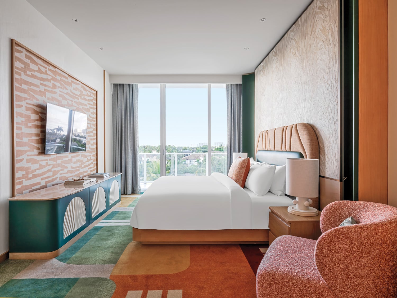 A suite bedroom opens to a balcony