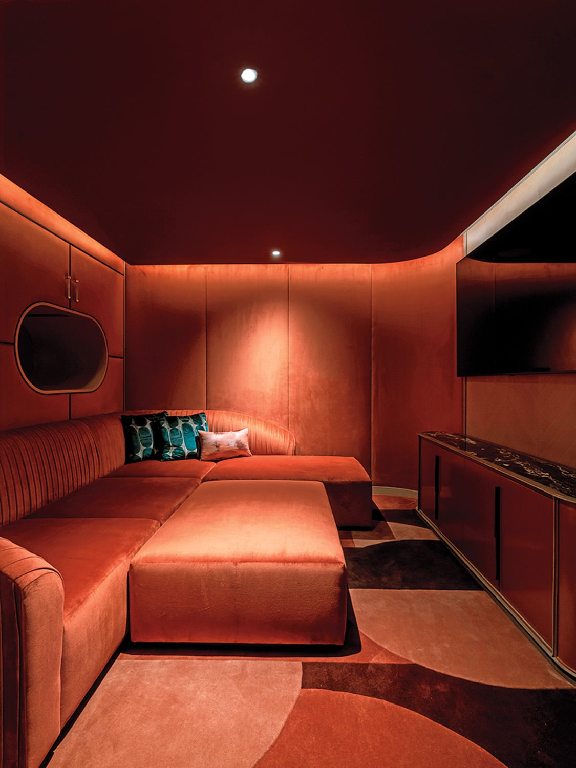 orange color drenched room with low couches