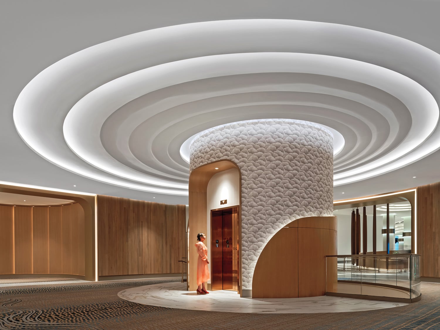 white circular pattern on ceiling of elevator core