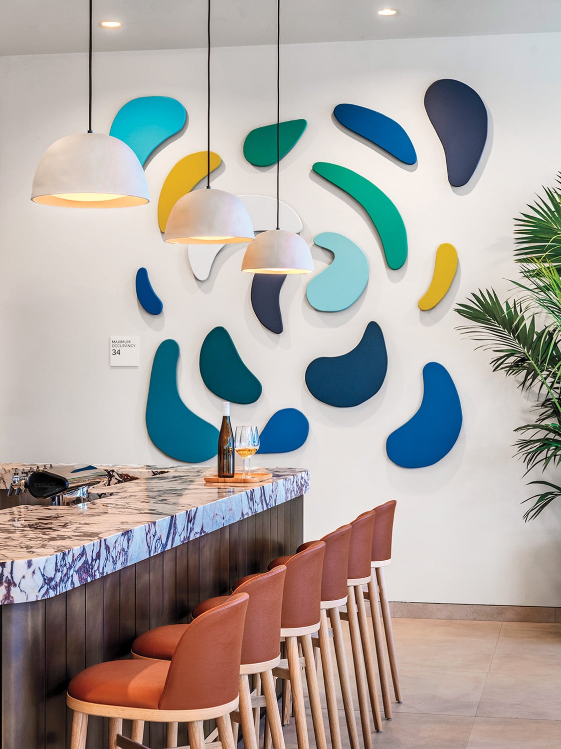 Glory Day McSharry’s acrylic on wood panel assemblage and In Common With’s Dome pendants at the Farewinds bar.