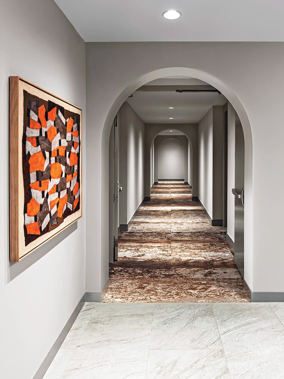 A corridor features Tom Dixon’s Iron carpet and Tectonic Displacement by Frédéric Heurlier Cimolai.