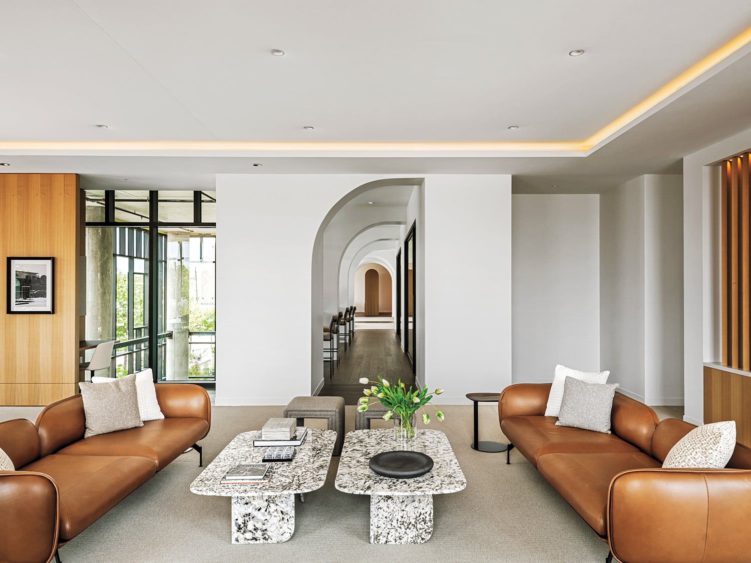 Pairs of Grupa’s Echo sofas and marble coffee tables center the coworking lounge.