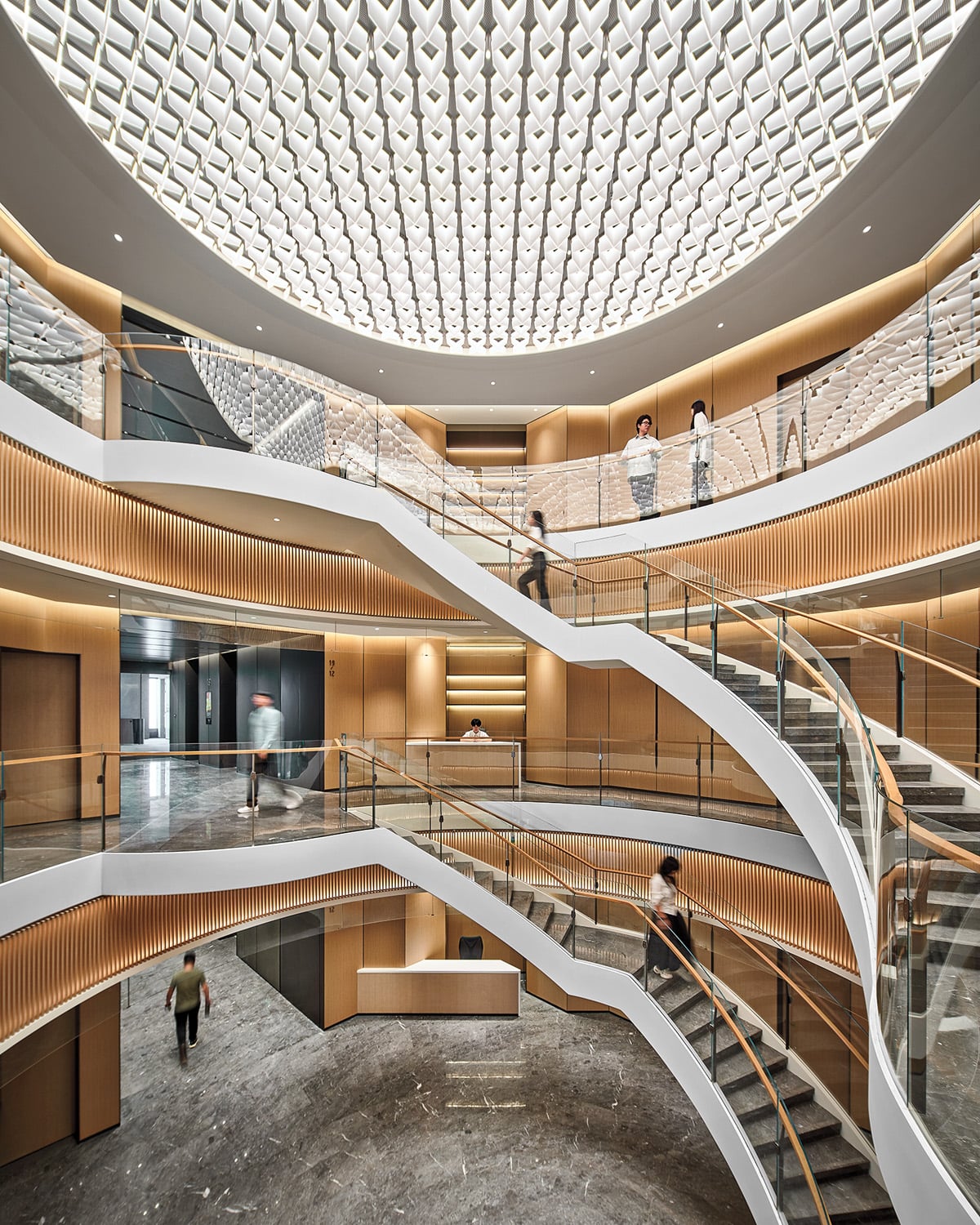winding staircase under chandelier