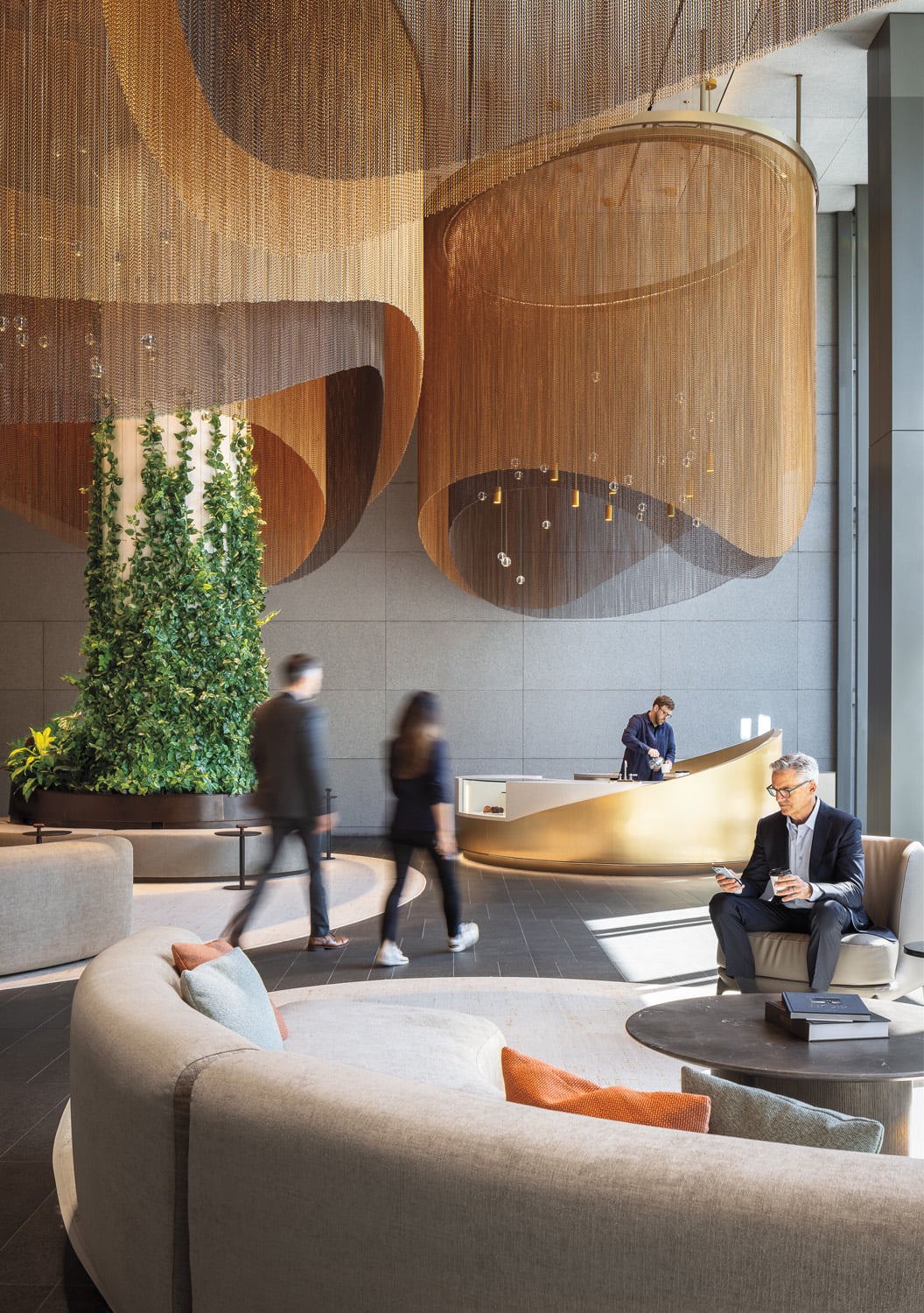 two people walking under gold chandelier