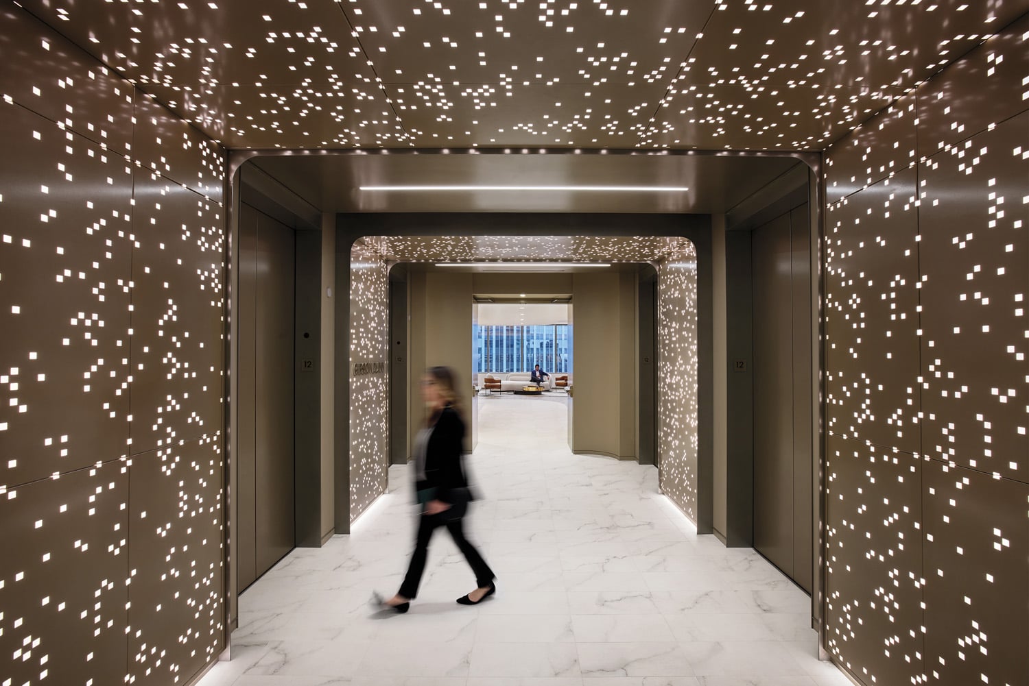 person in elevator bank with brain and white speckled walls
