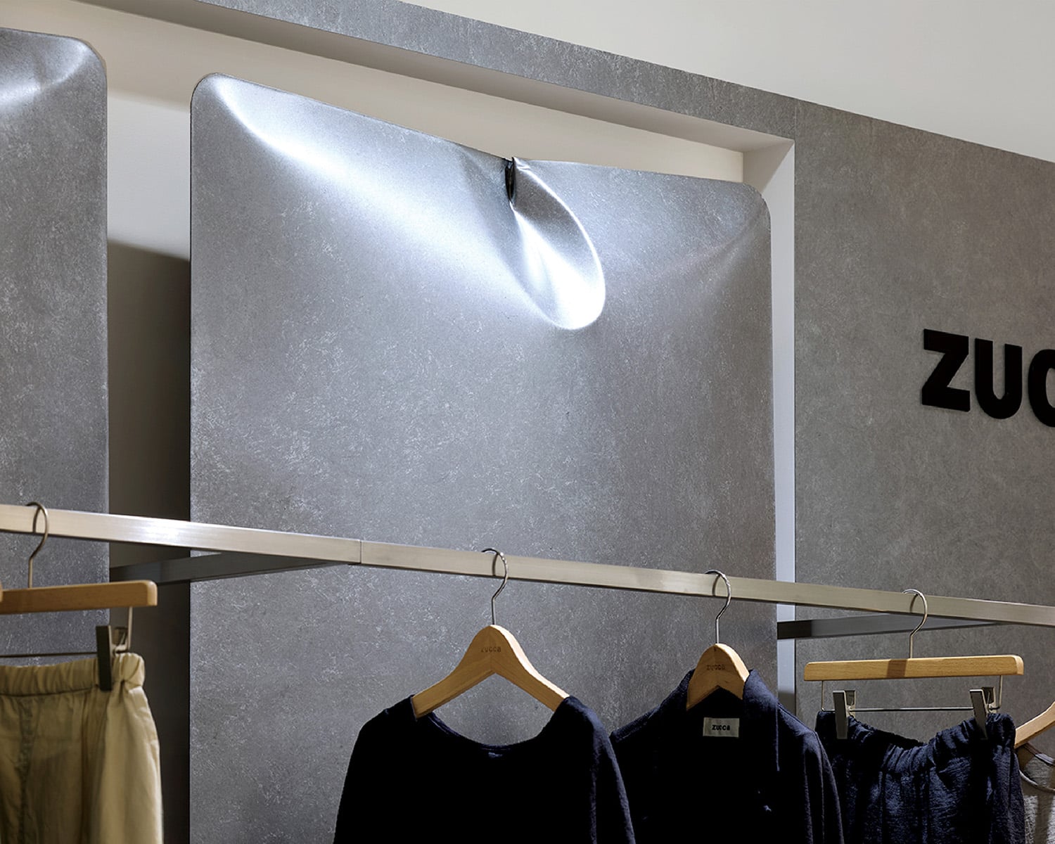 A display of clothes hanging on a wall