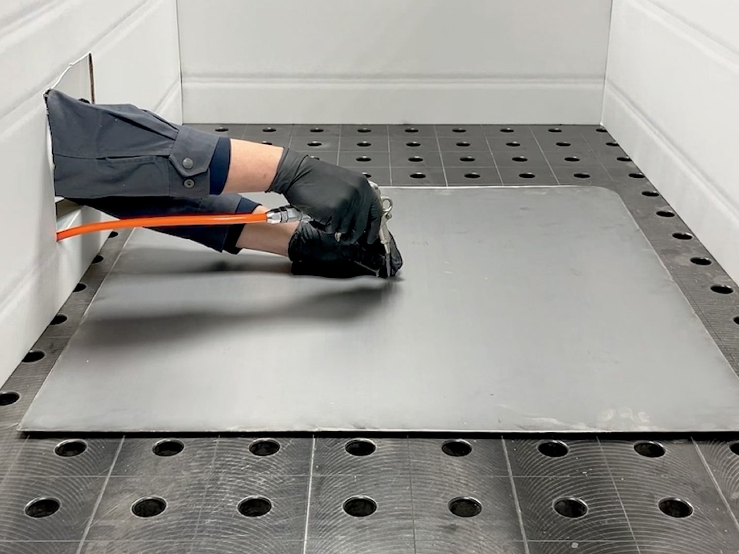 A man is laying down a piece of metal