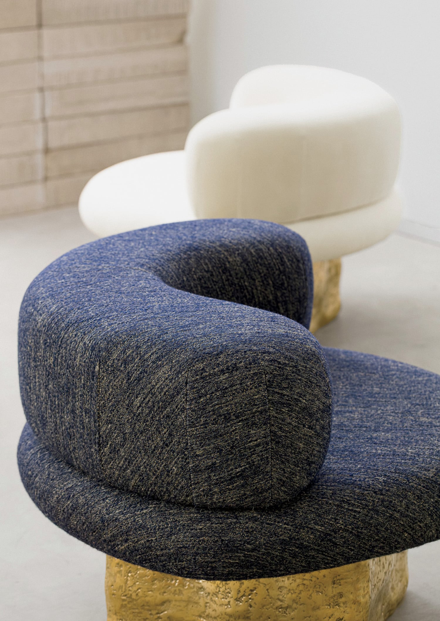 A blue and white couch and a white chair