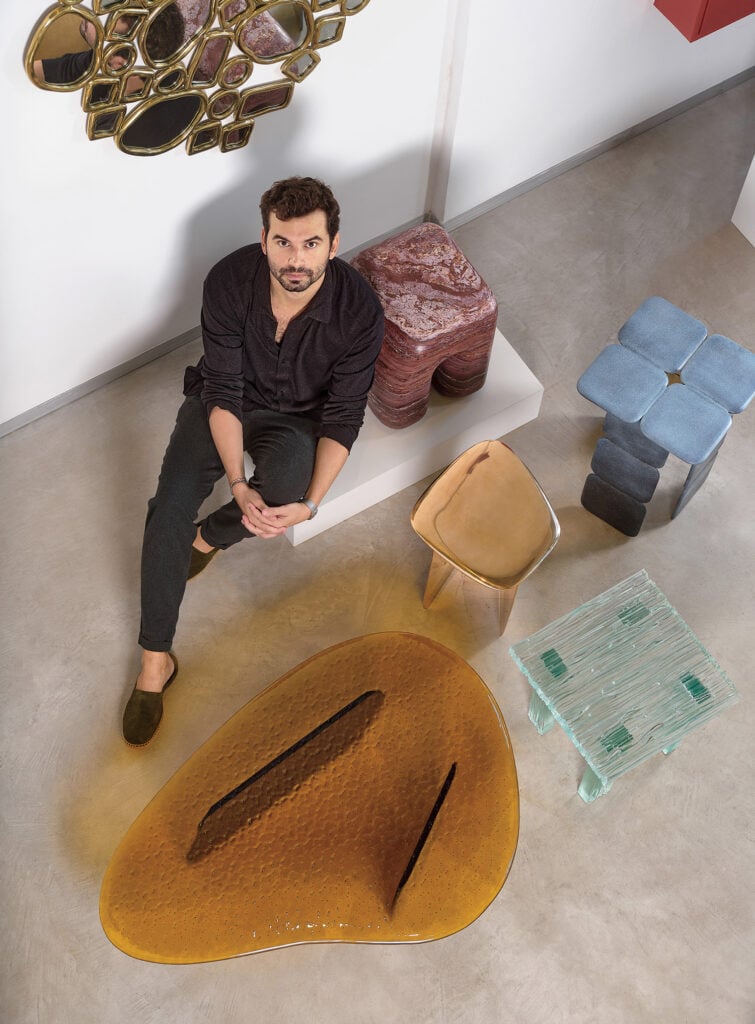 A man sitting on the floor with a skateboard