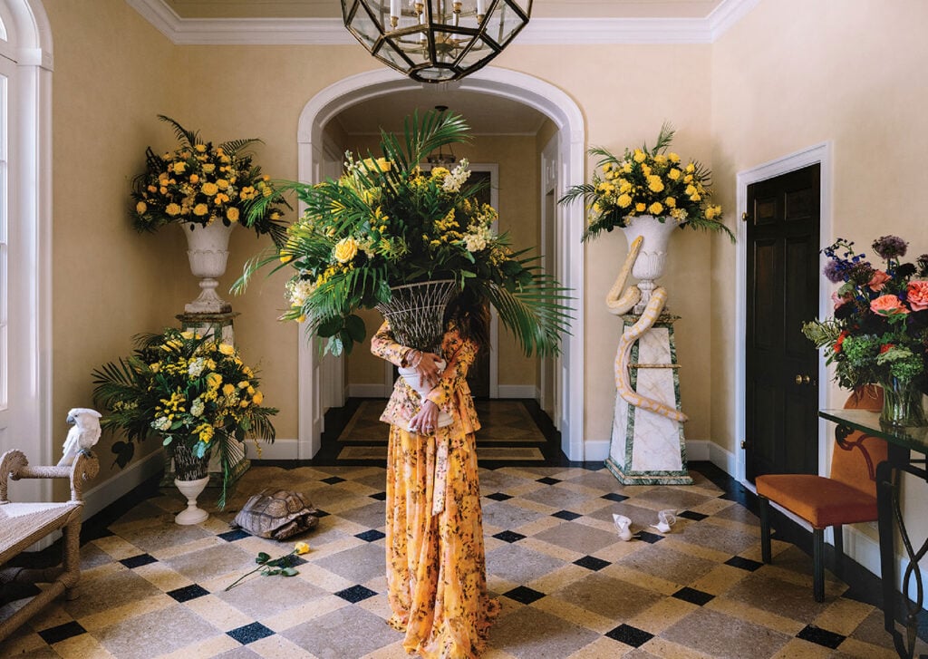 A woman in a yellow dress standing in a room.