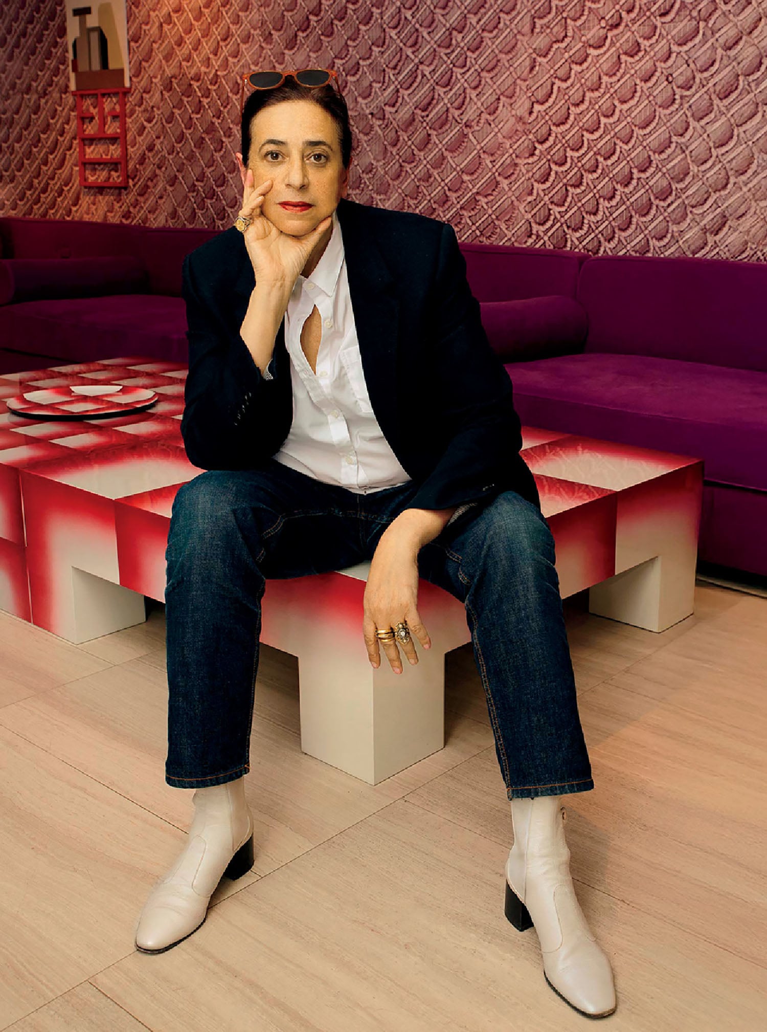 A man sitting on a bench in a room.