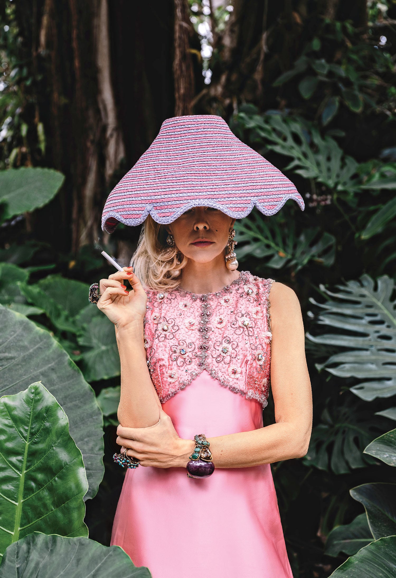 A woman in a pink dress and a pink hat.