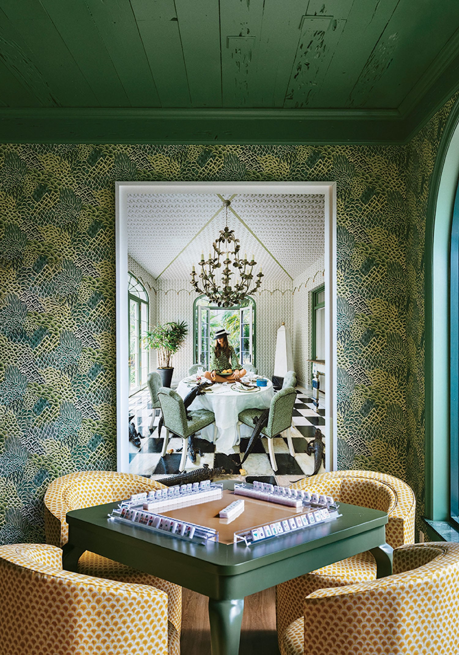 A room with a table and chairs and a mirror.