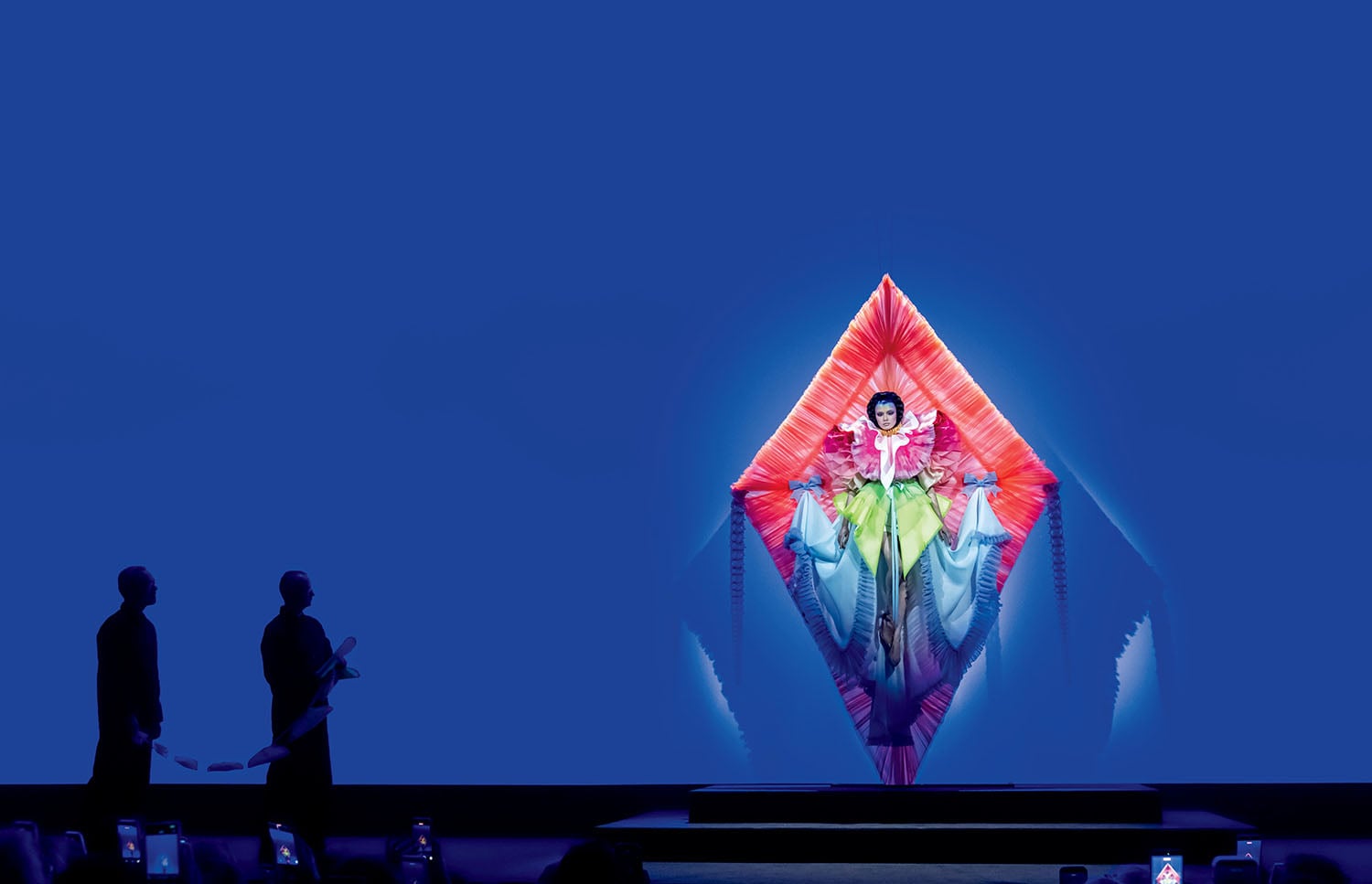 A woman in a dress standing on a stage.