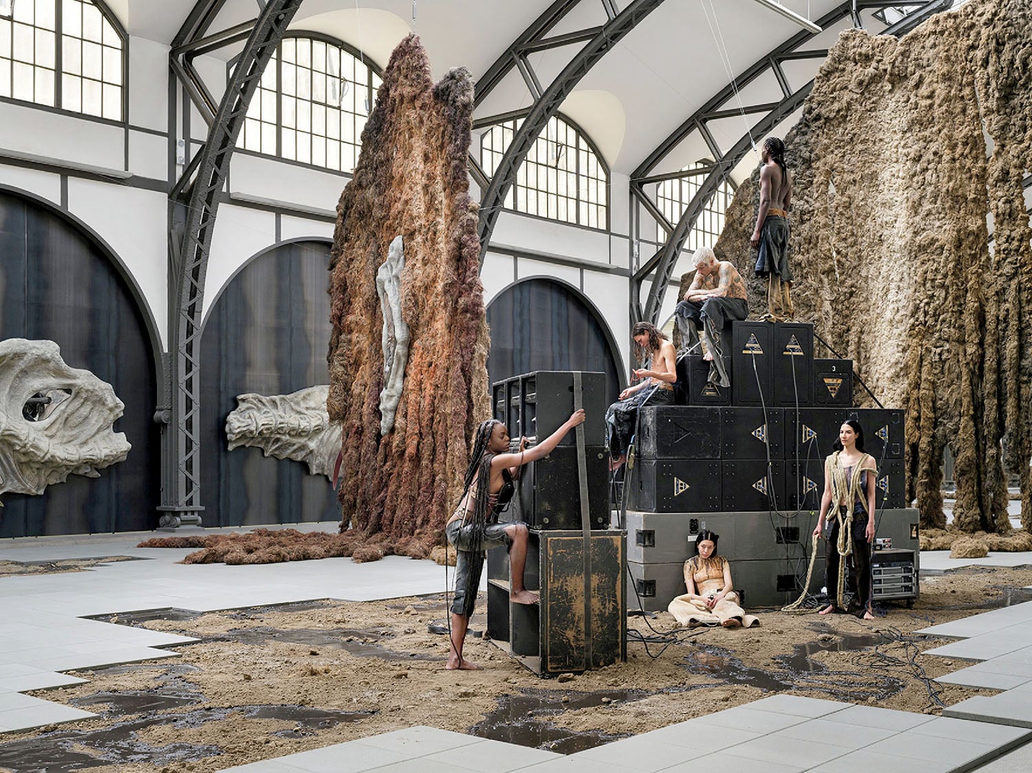 A group of people standing around a large sculpture.