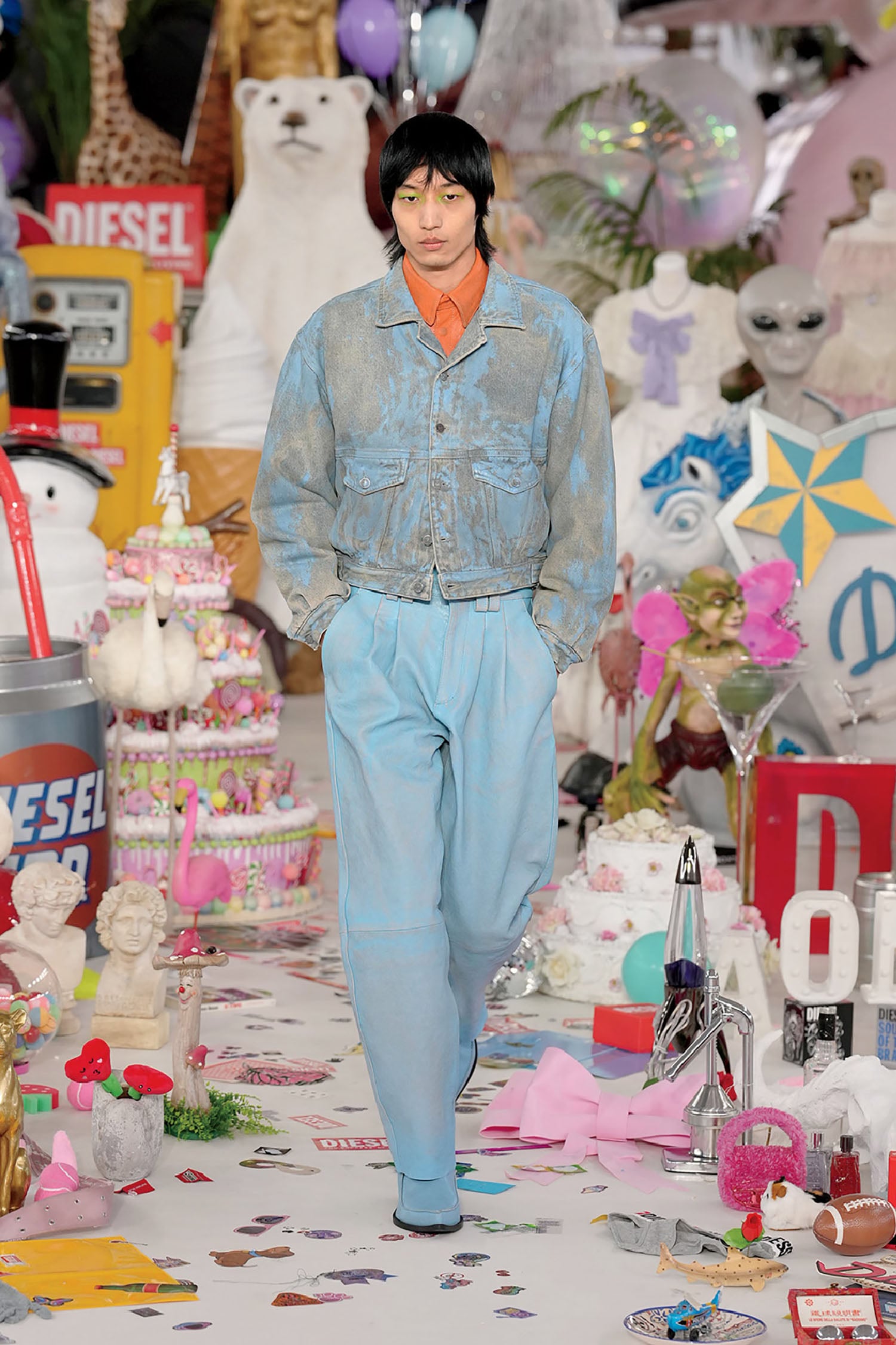 A woman walking down a runway with lots of toys.