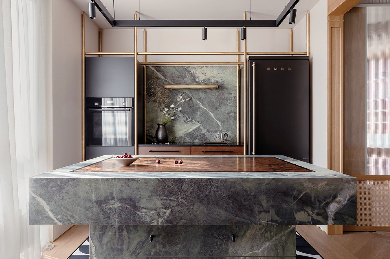 A kitchen with a marble island and a marble countertop.