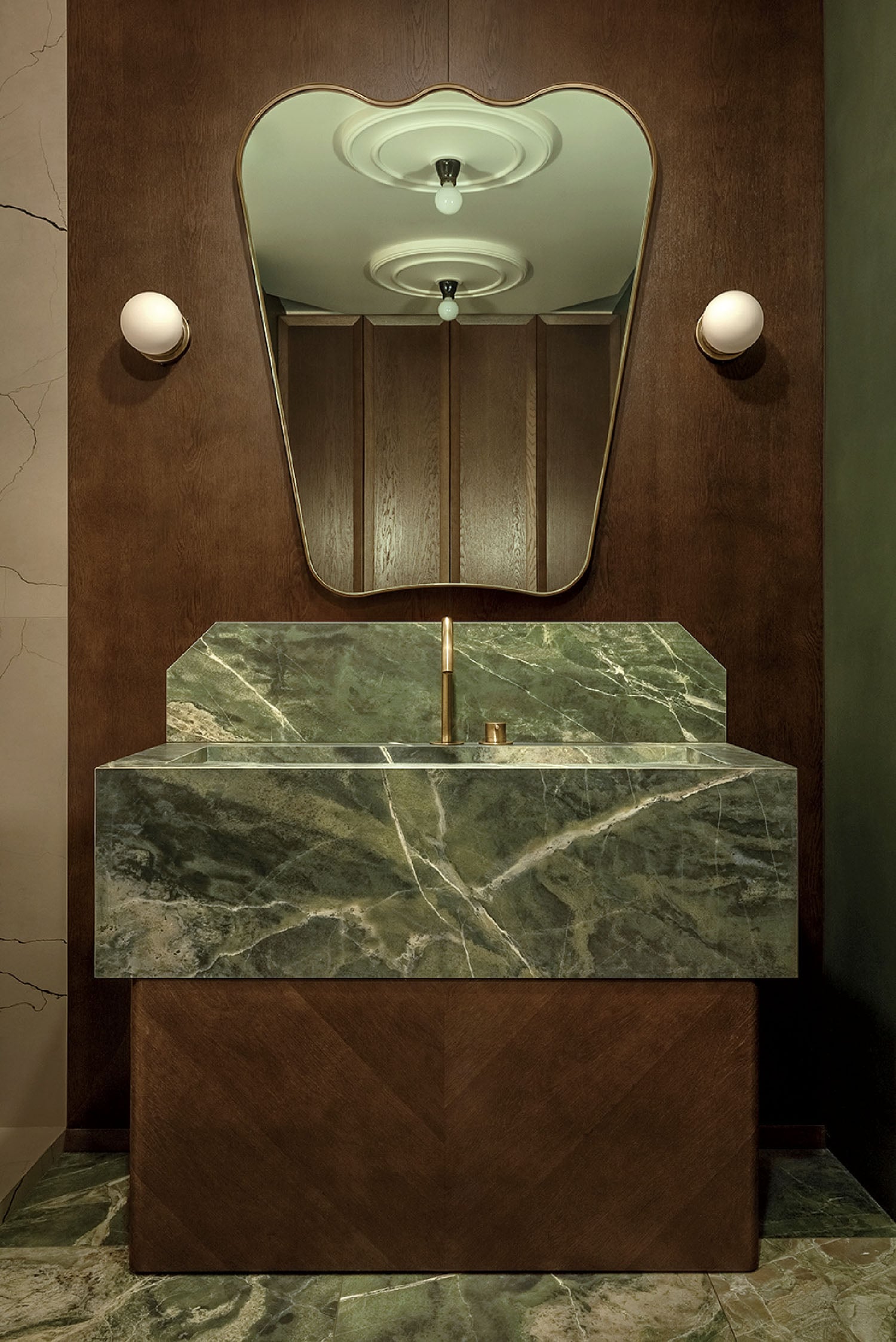 A bathroom with a marble sink and a mirror.