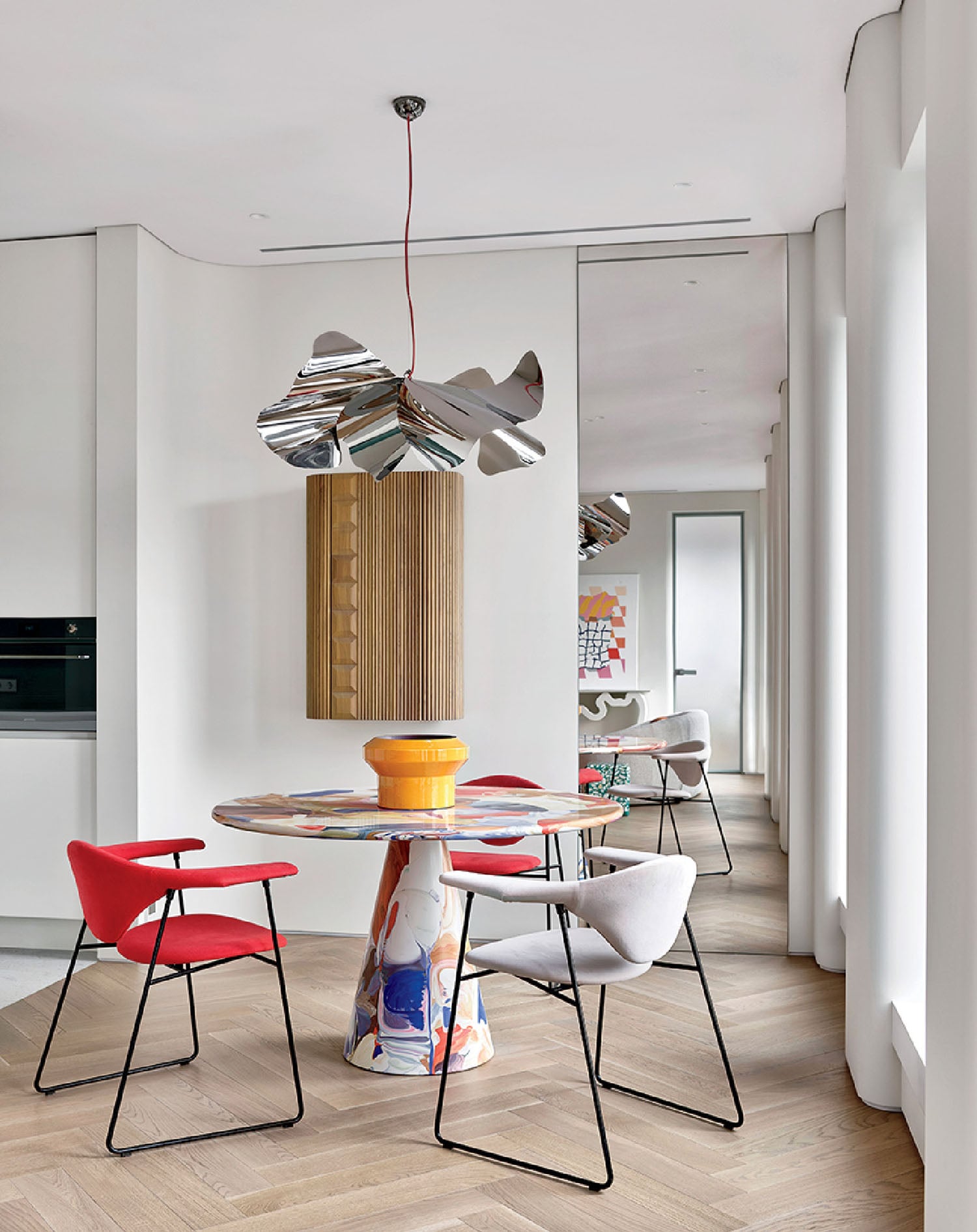 A dining room with a table and chairs.