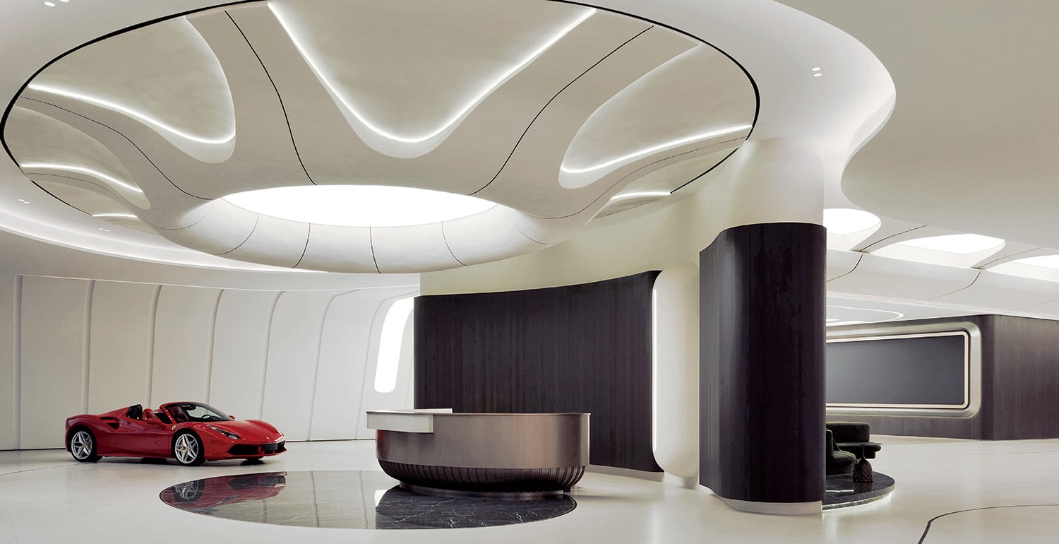 A car is parked in a modern car showroom
