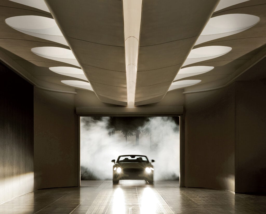 A car is parked in a dark room