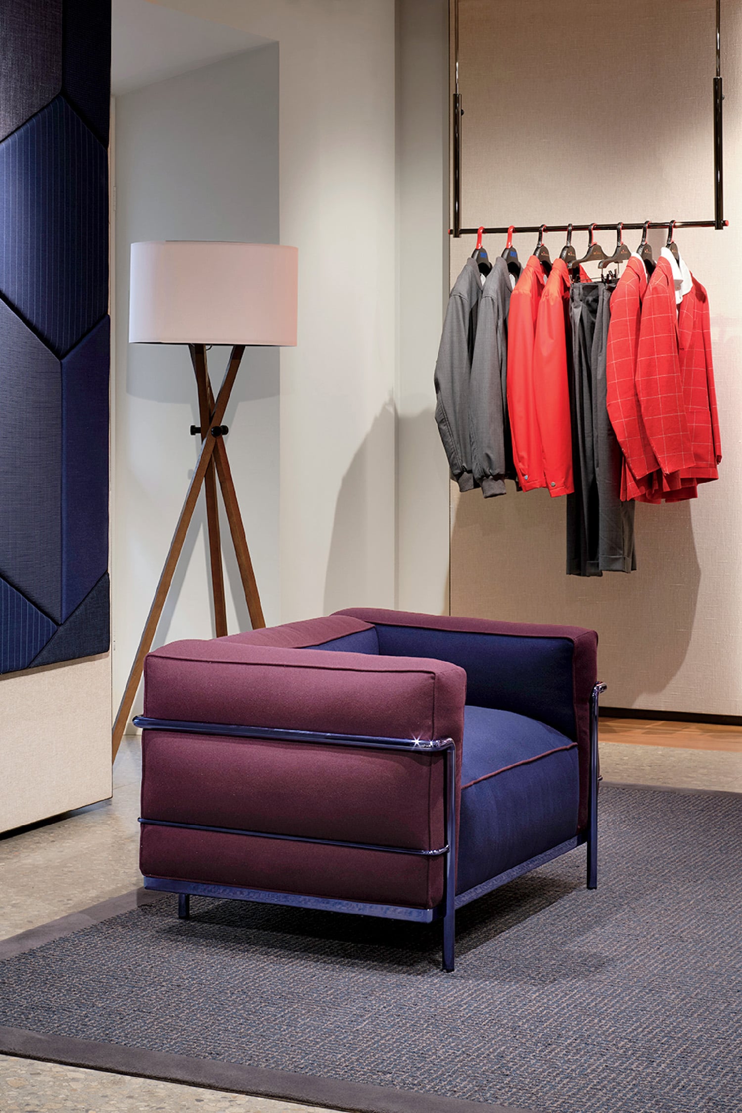 A blue ottoman with a red shirt hanging on it