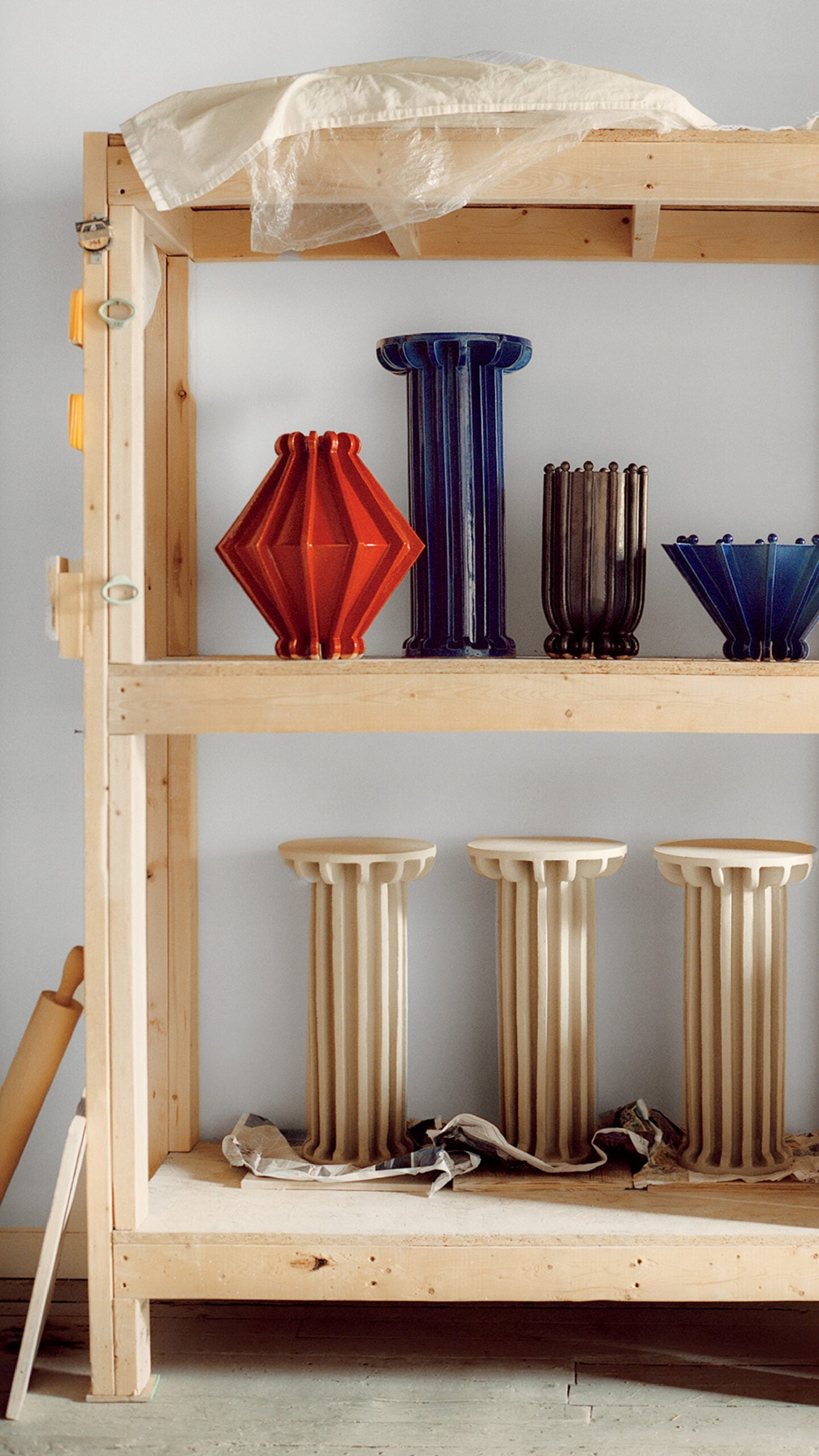 A shelf with a bunch of vases on it