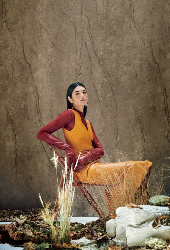 A woman in a yellow dress and a red jacket
