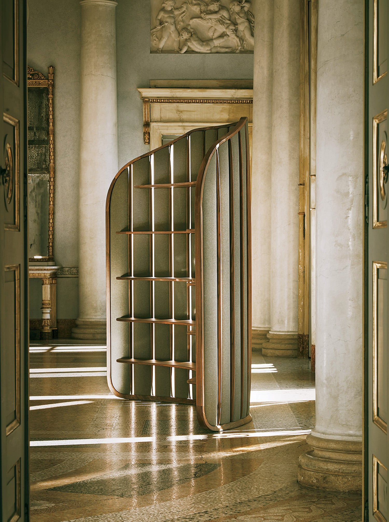A room with a large mirror and a door