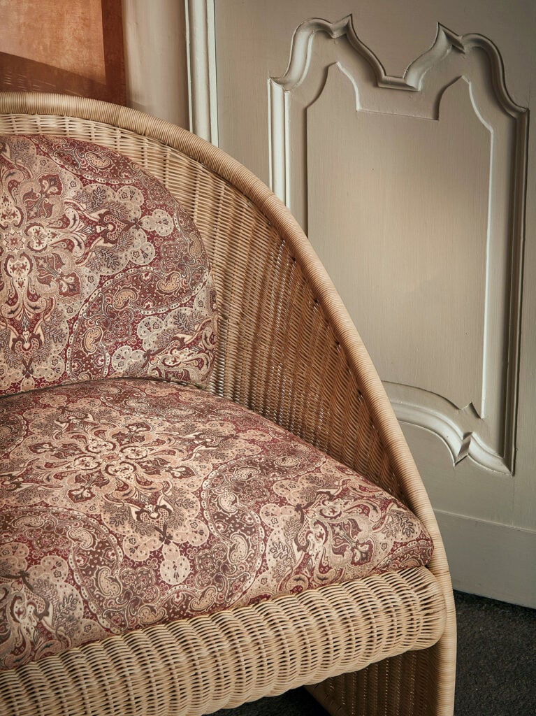 A wicker chair with a floral pattern