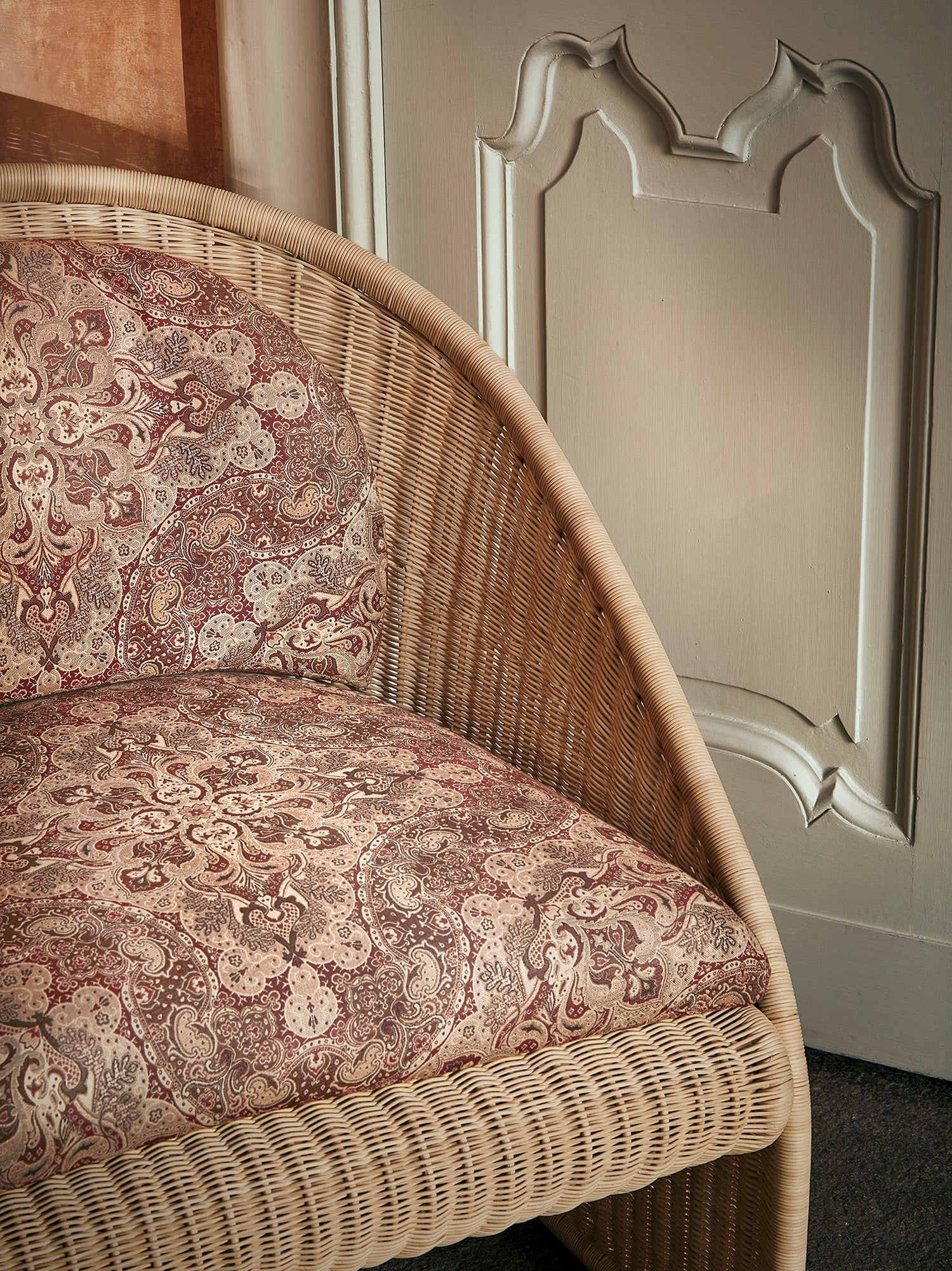 A wicker chair with a floral pattern