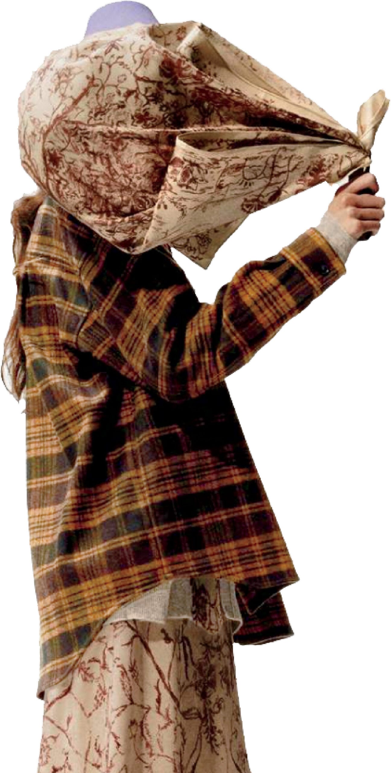 A woman in a plaid coat and scarf