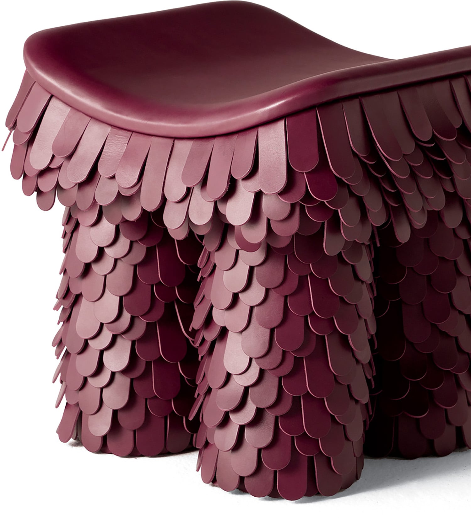 "A stool with a large, red leather seat"