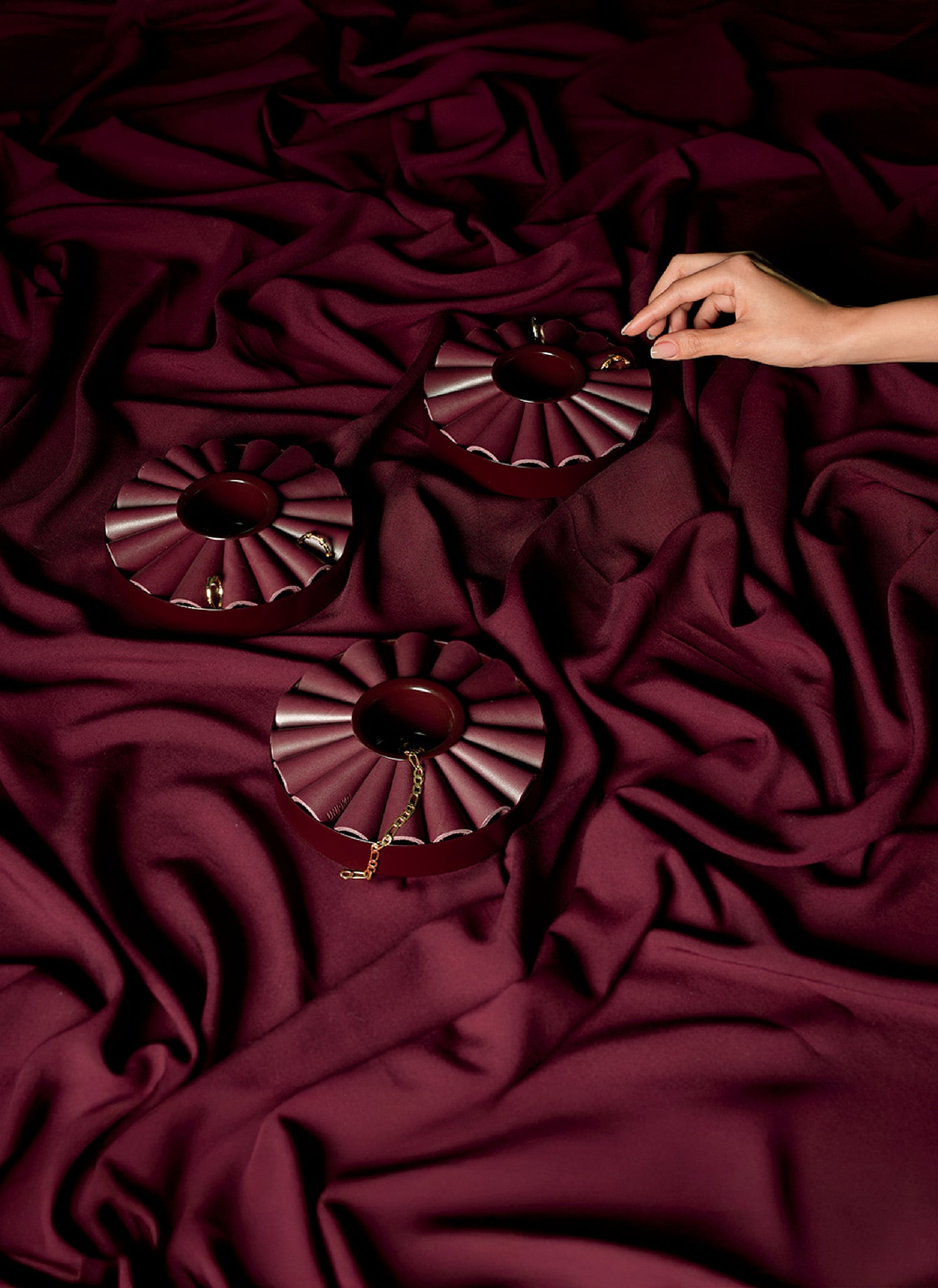 A person is laying on a bed with a red blanket