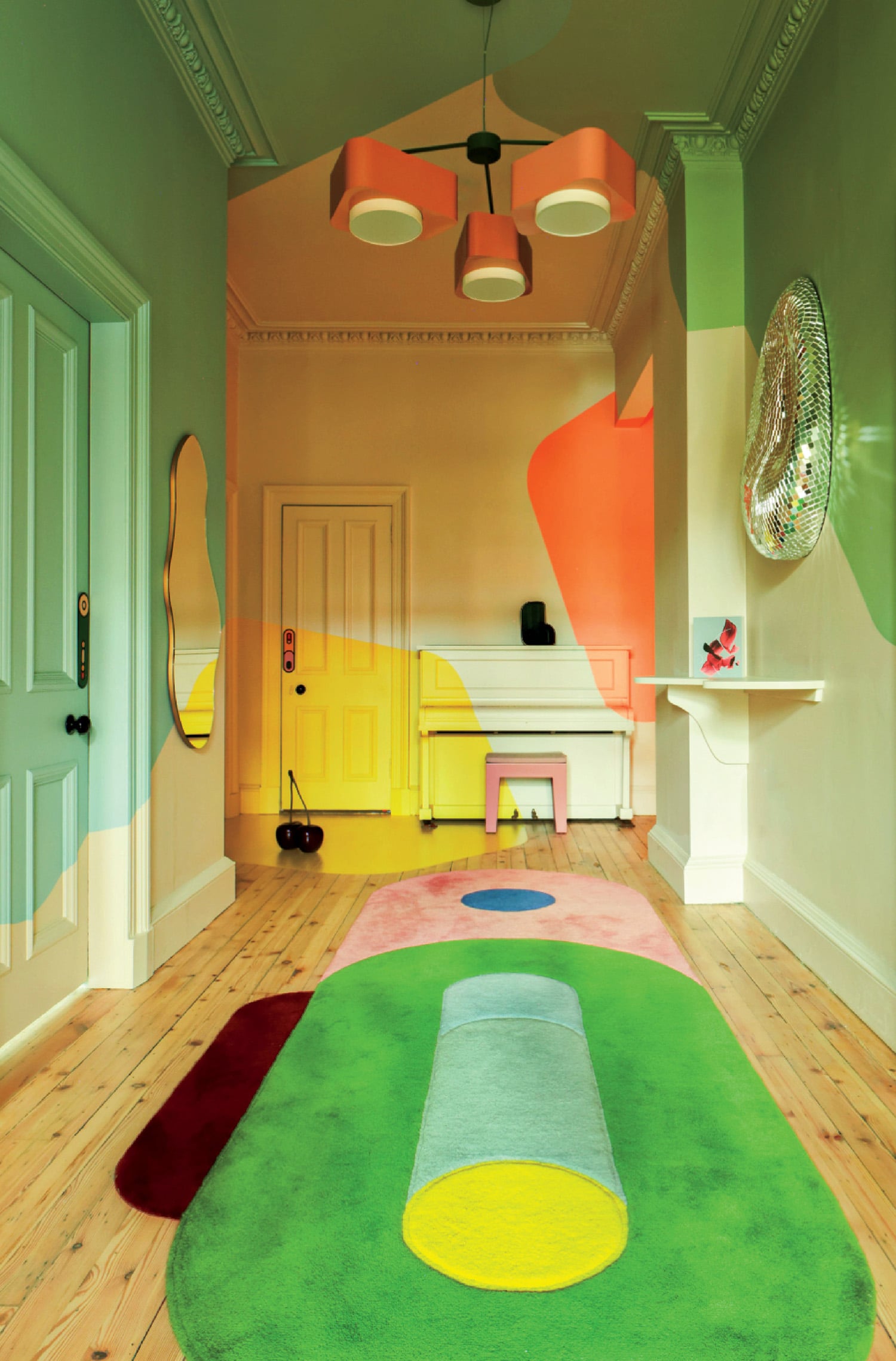 A colorful rug in a room with a ceiling fan