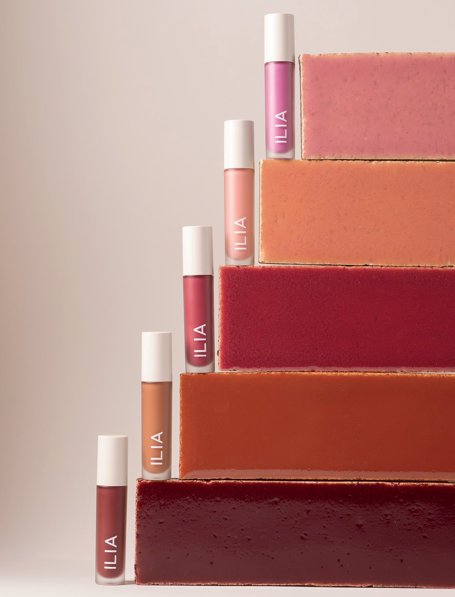 A stack of different shades of lipstick
