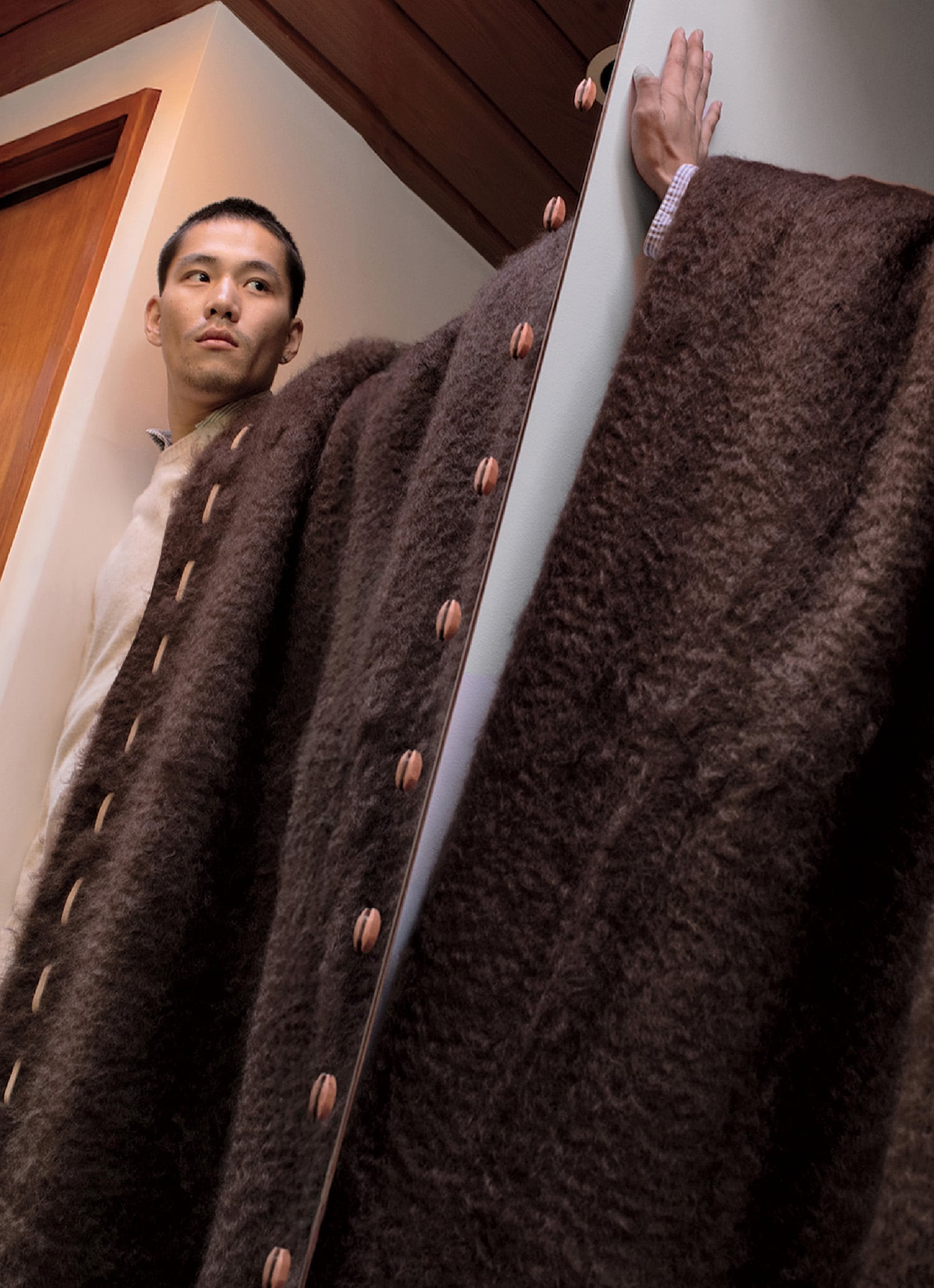 A man in a brown coat