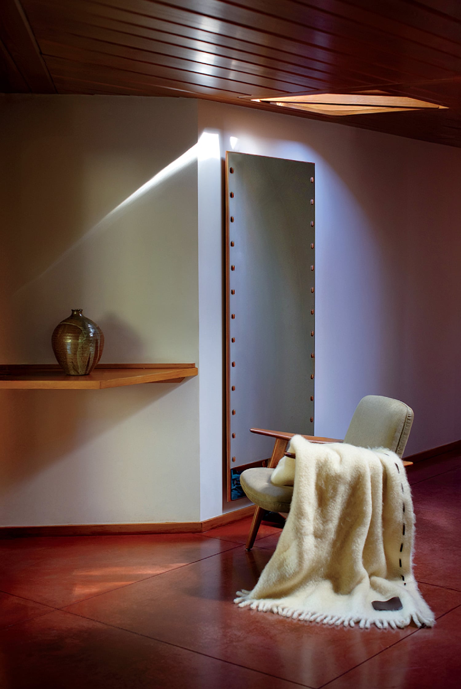 A chair with a blanket on it in a room