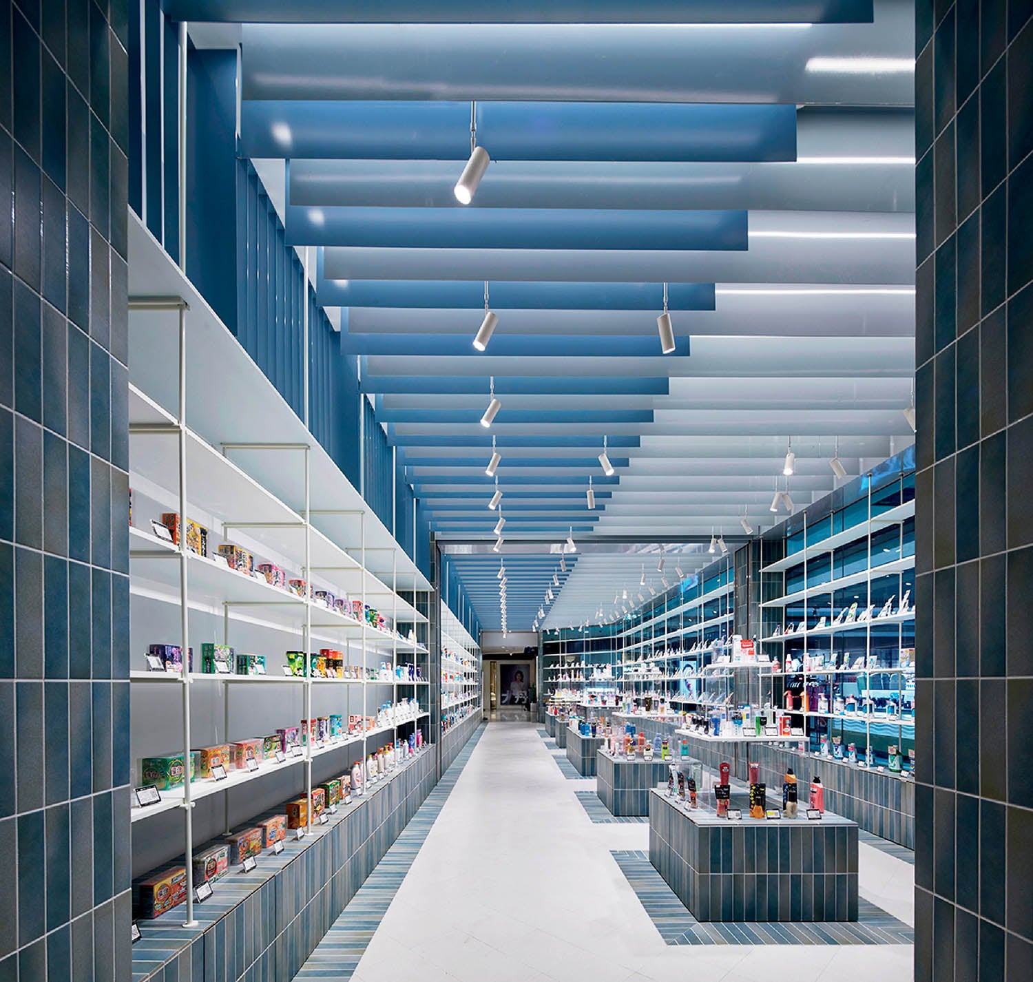 A long hallway with shelves and shelves filled with various item.