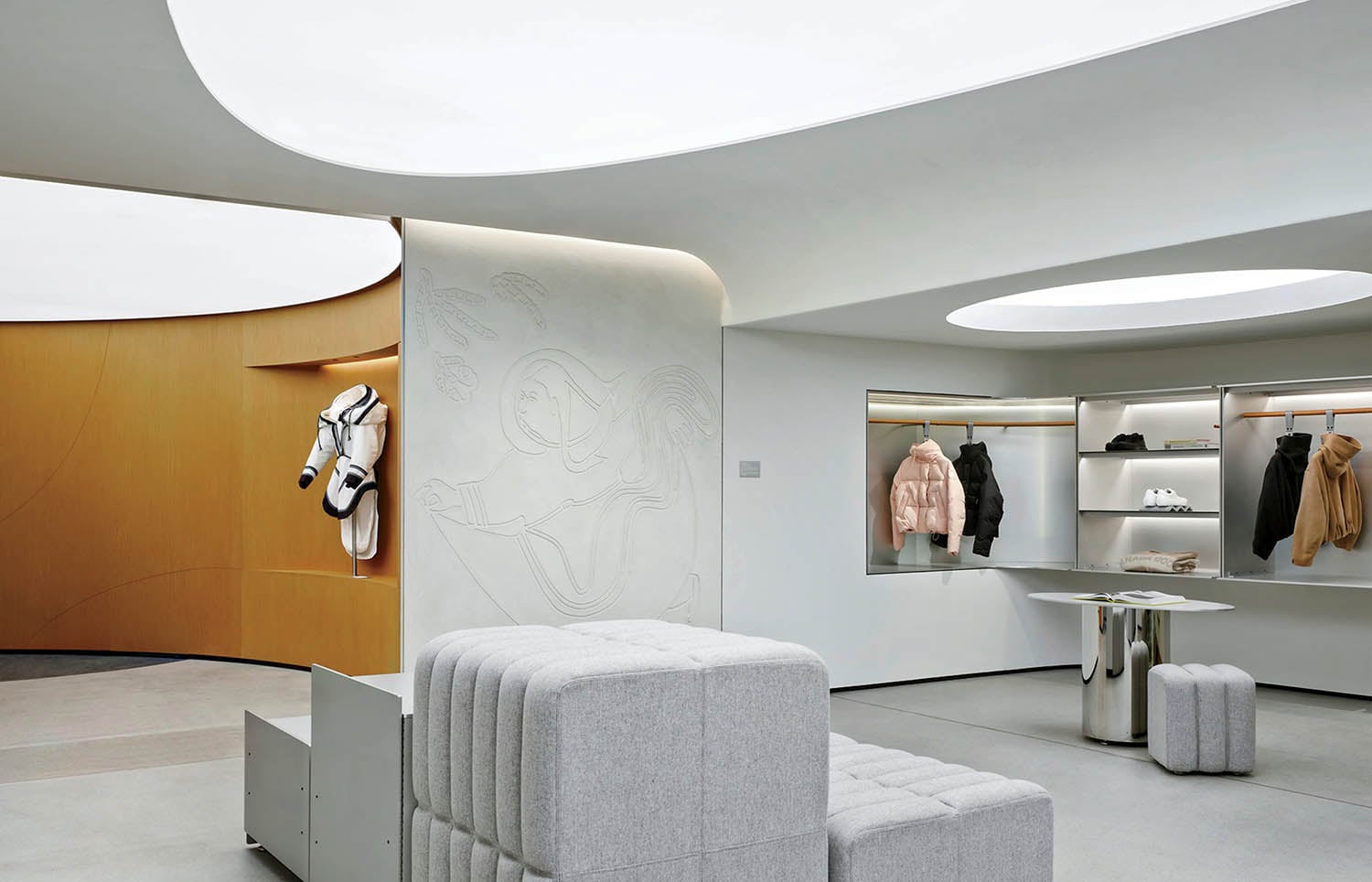 A room with a couch and a coat rack.