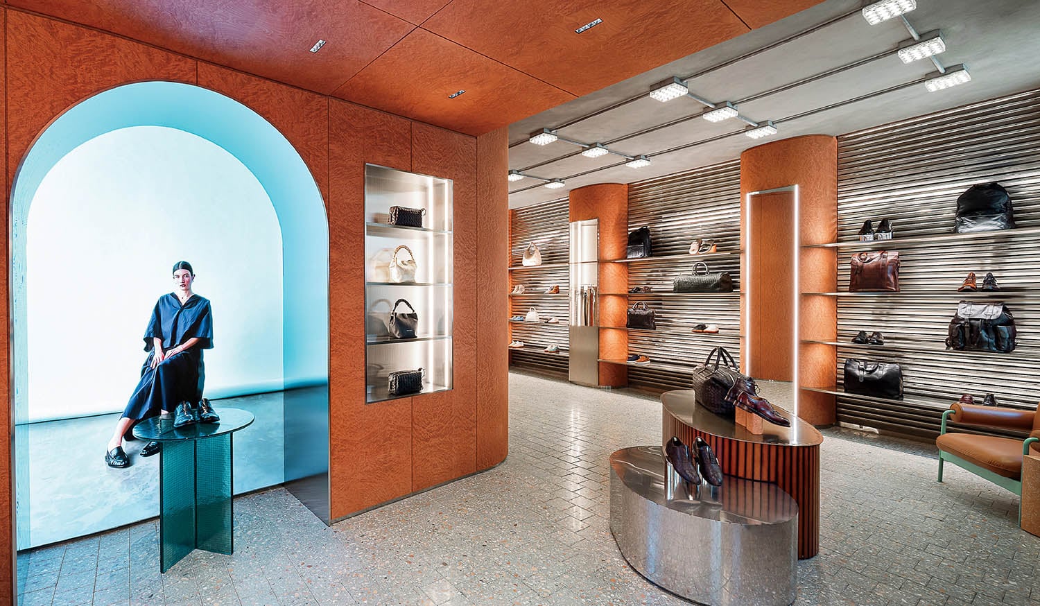 A man sitting on a bench in a store.