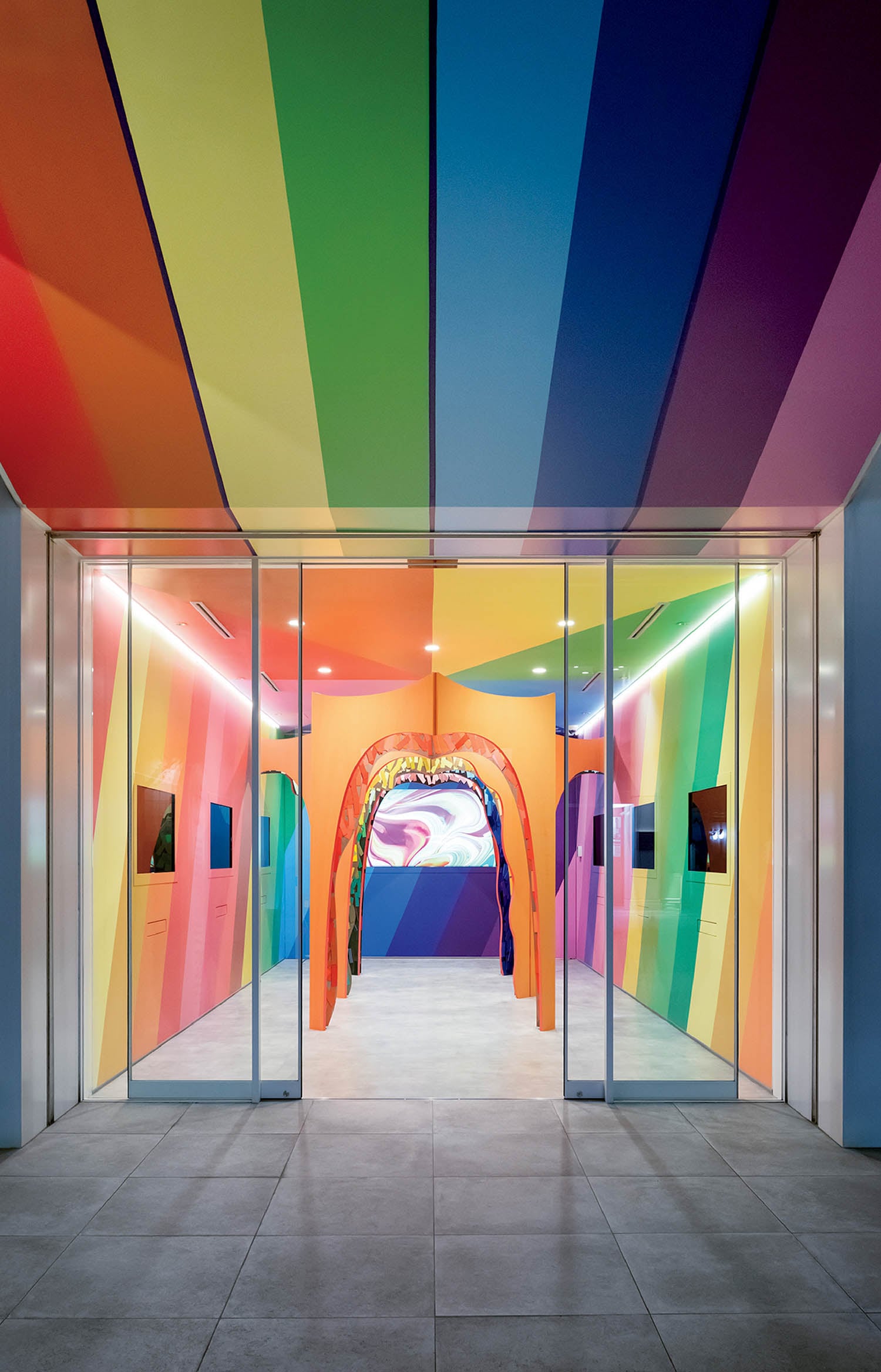 A colorfully painted building with a rainbow colored ceiling.