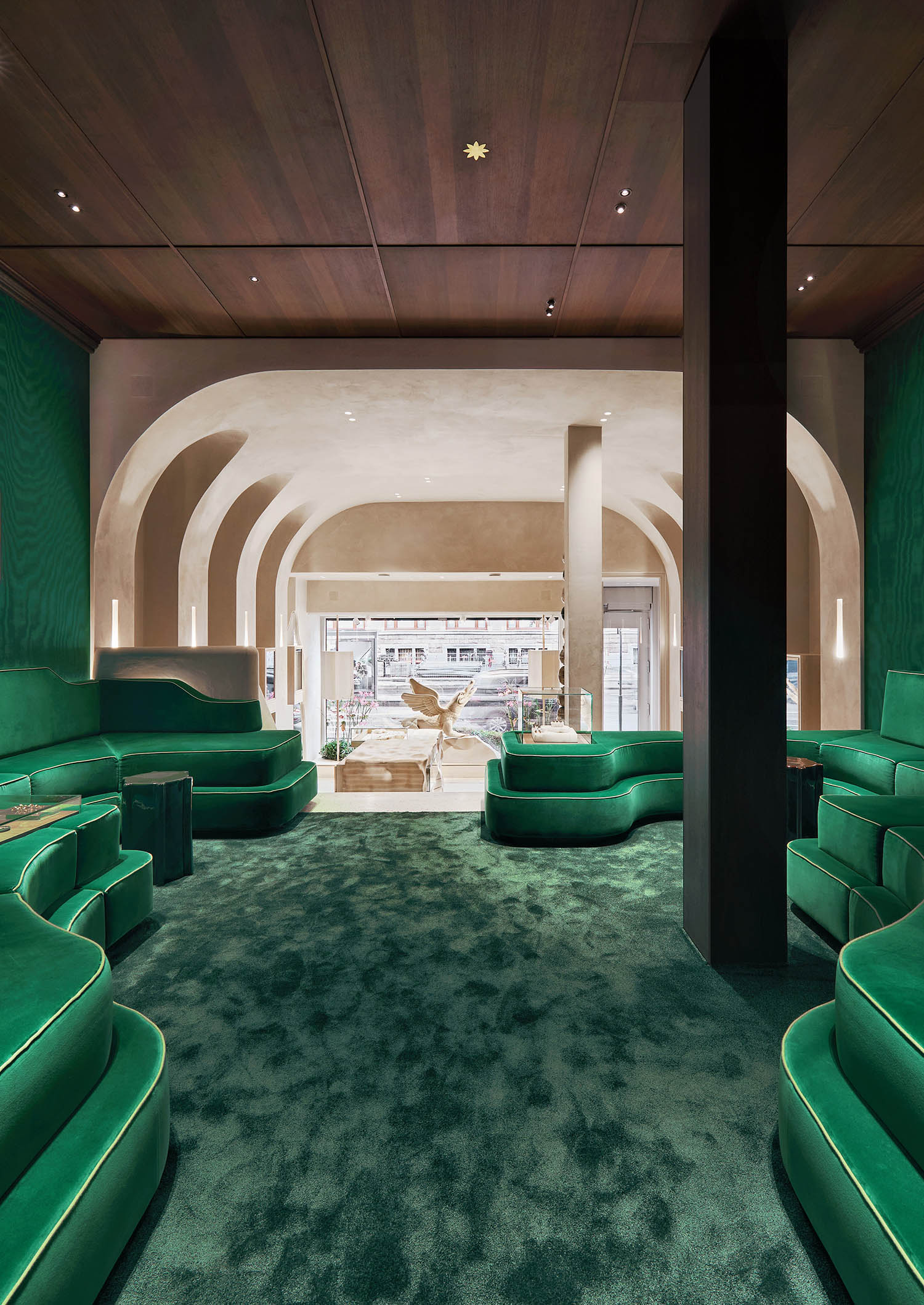 A room with green chairs and a table.