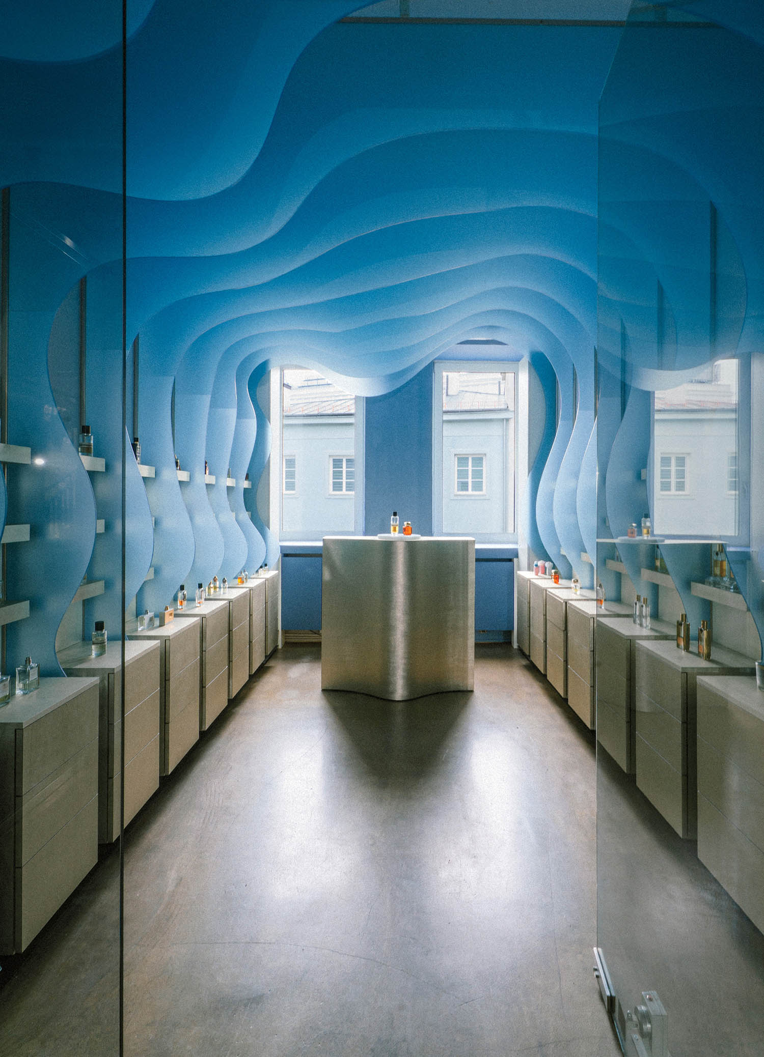 A bathroom with a blue wall and a mirror.