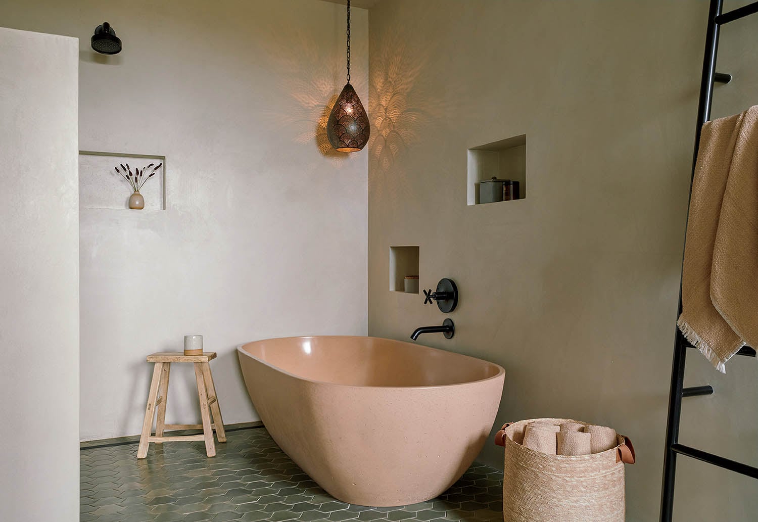 A bathroom with a large bathtub and a towel rack.