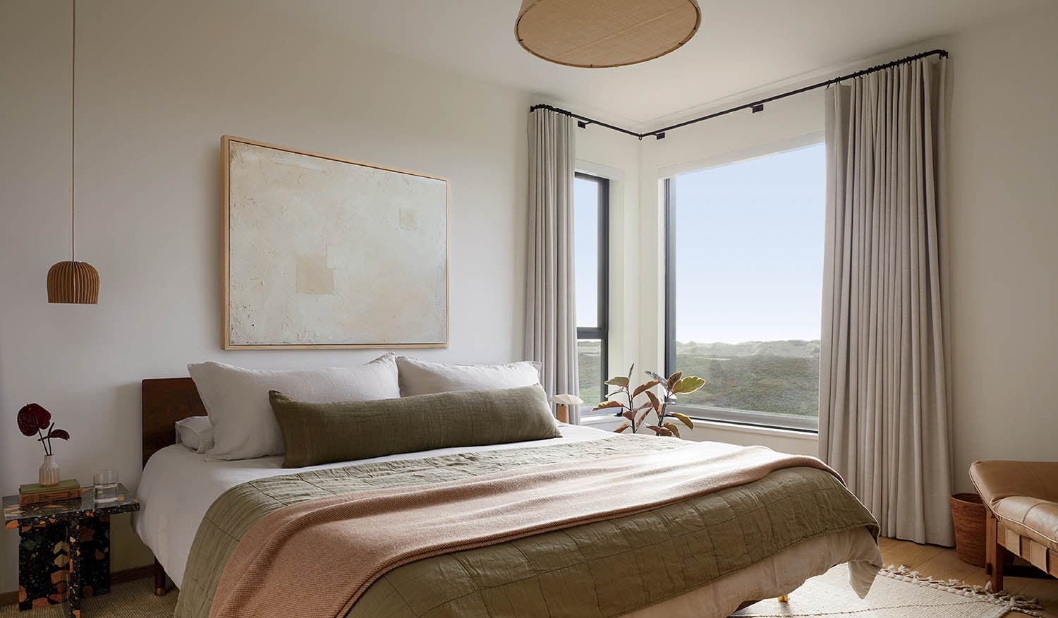 A bedroom with a bed and a chair.