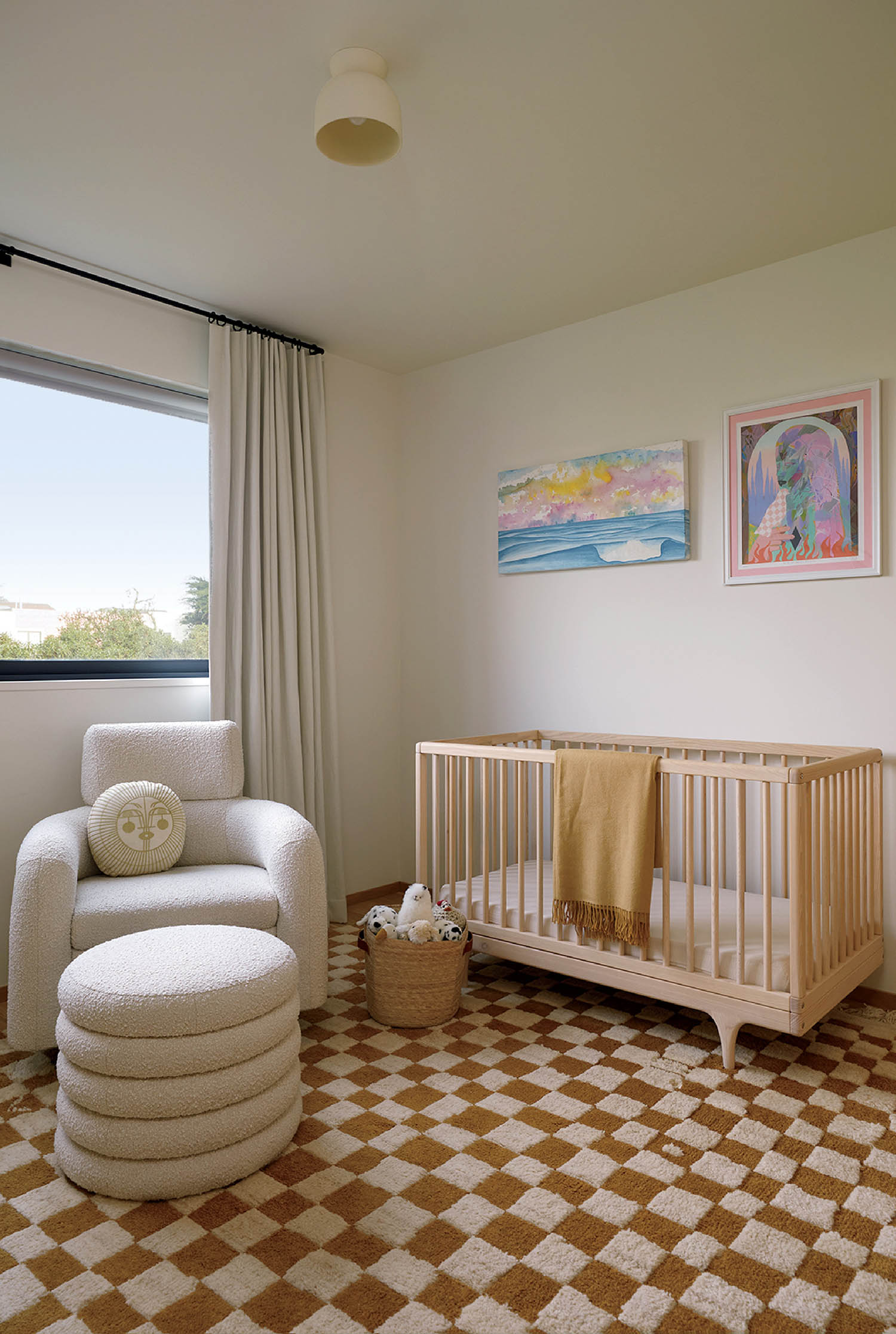 A baby's room with a cribt and a chair.