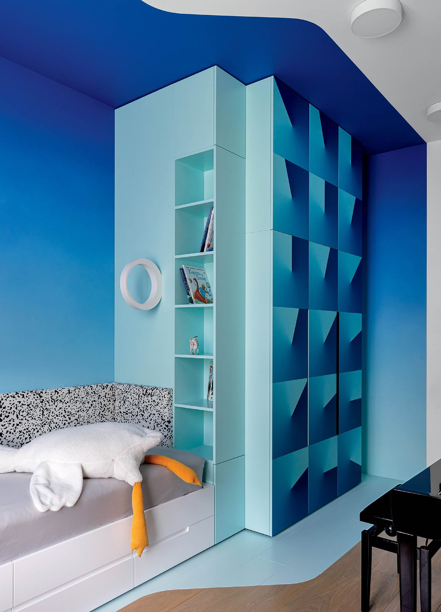 A bedroom with a bed and a desk.