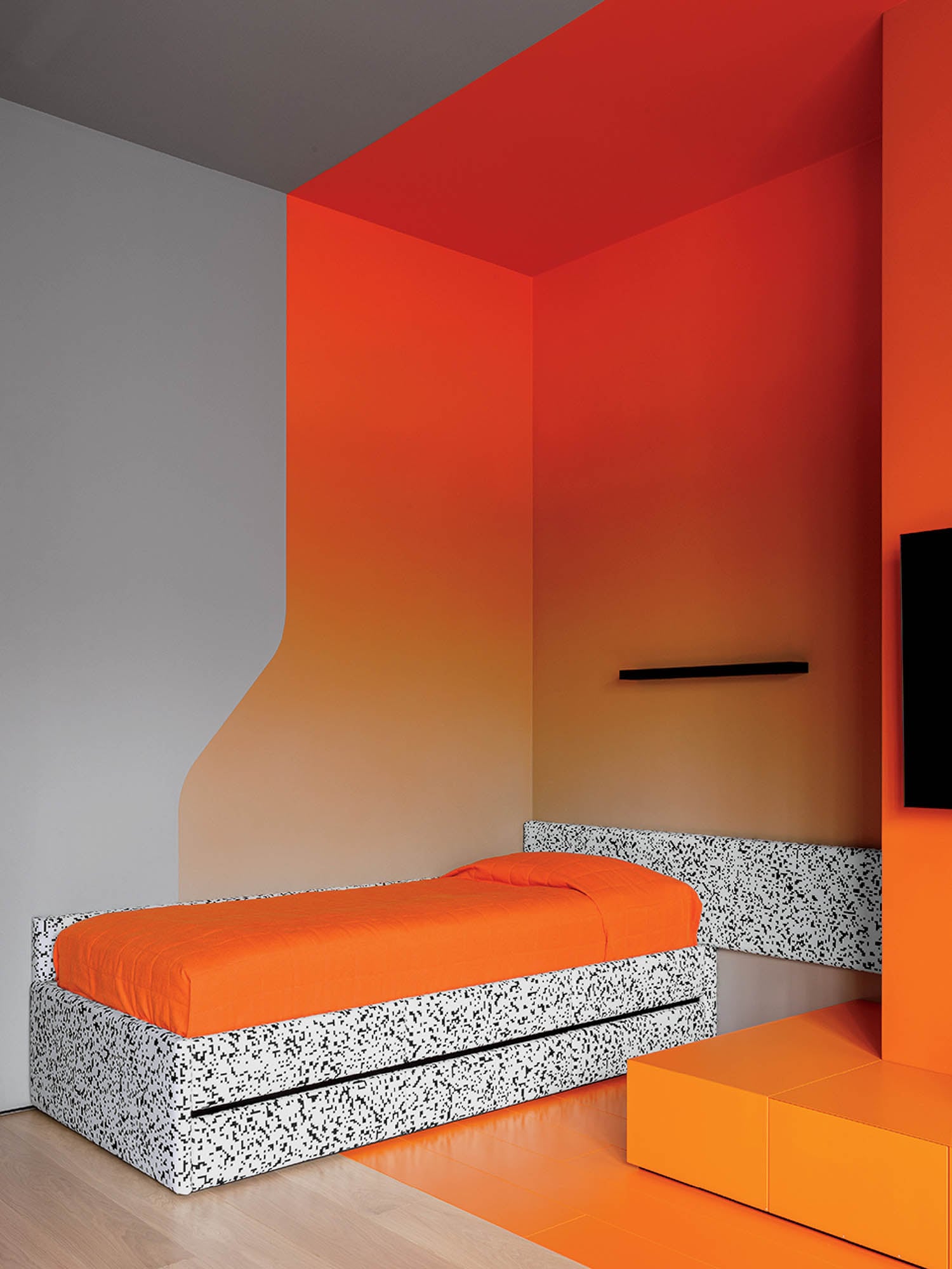 A bedroom with a bed and a television.