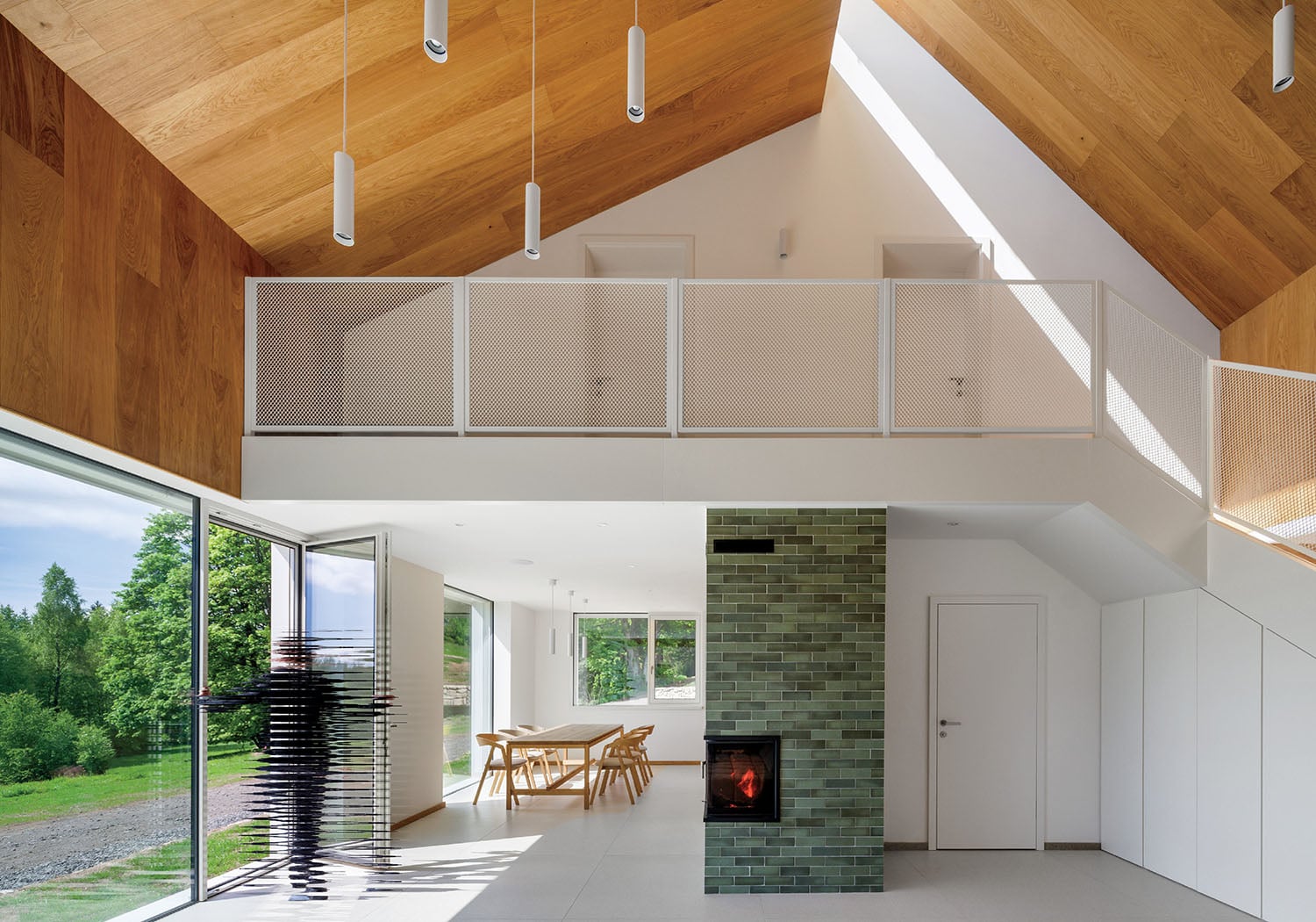 A living room with a fireplace and a wooden ceiling.